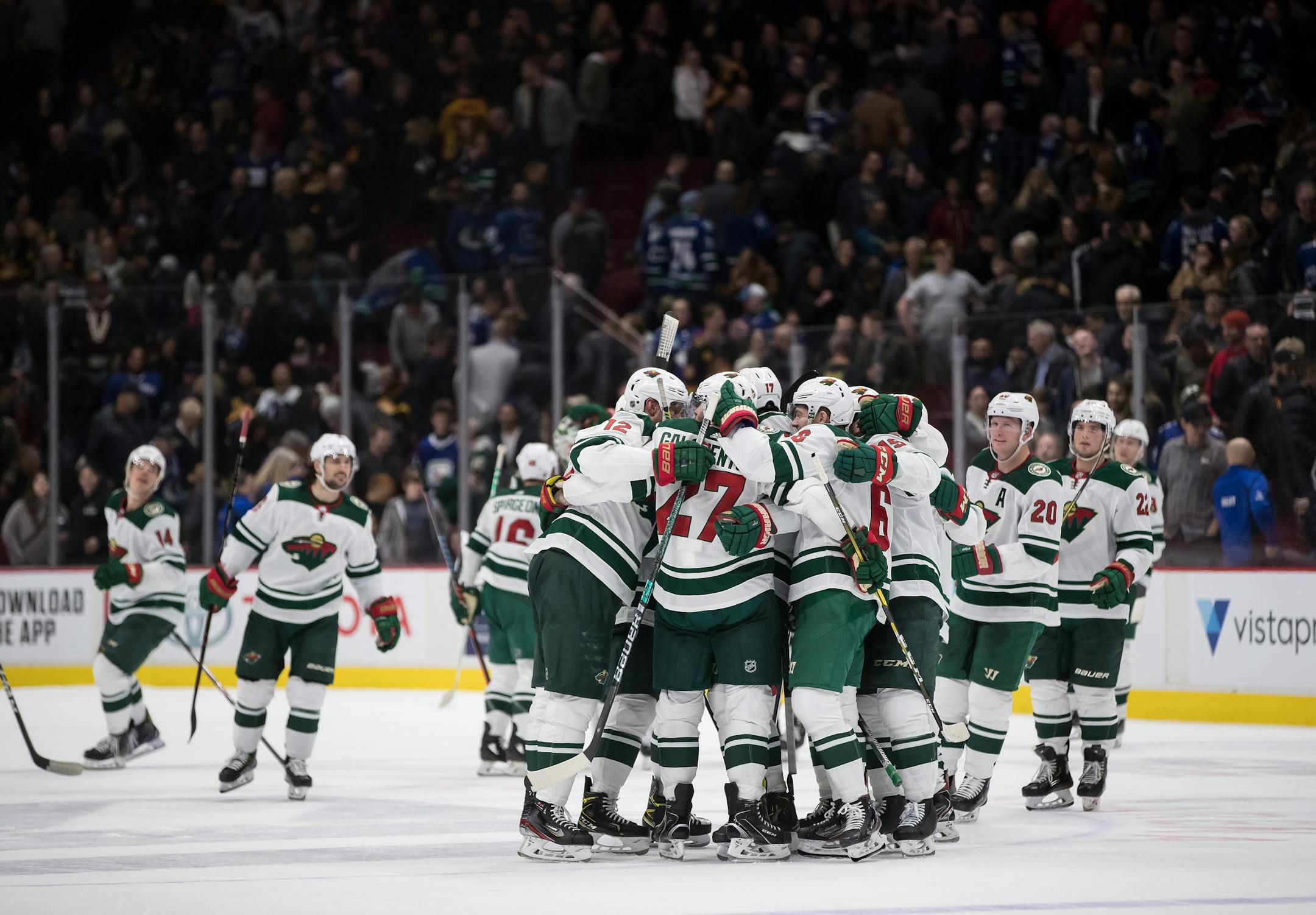 The Wild's Alex Galchenyuk and teammates celebrate his shootout goal against the Canucks on Wednesday night. The game is part of the Wild's father-son road trip.
