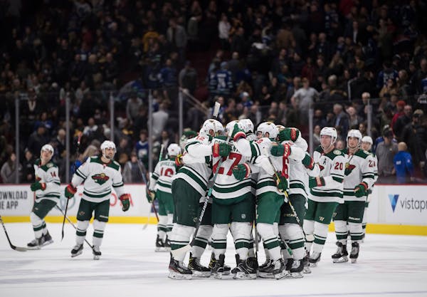 The Wild's Alex Galchenyuk and teammates celebrate his shootout goal against the Canucks on Wednesday night. The game is part of the Wild's father-son