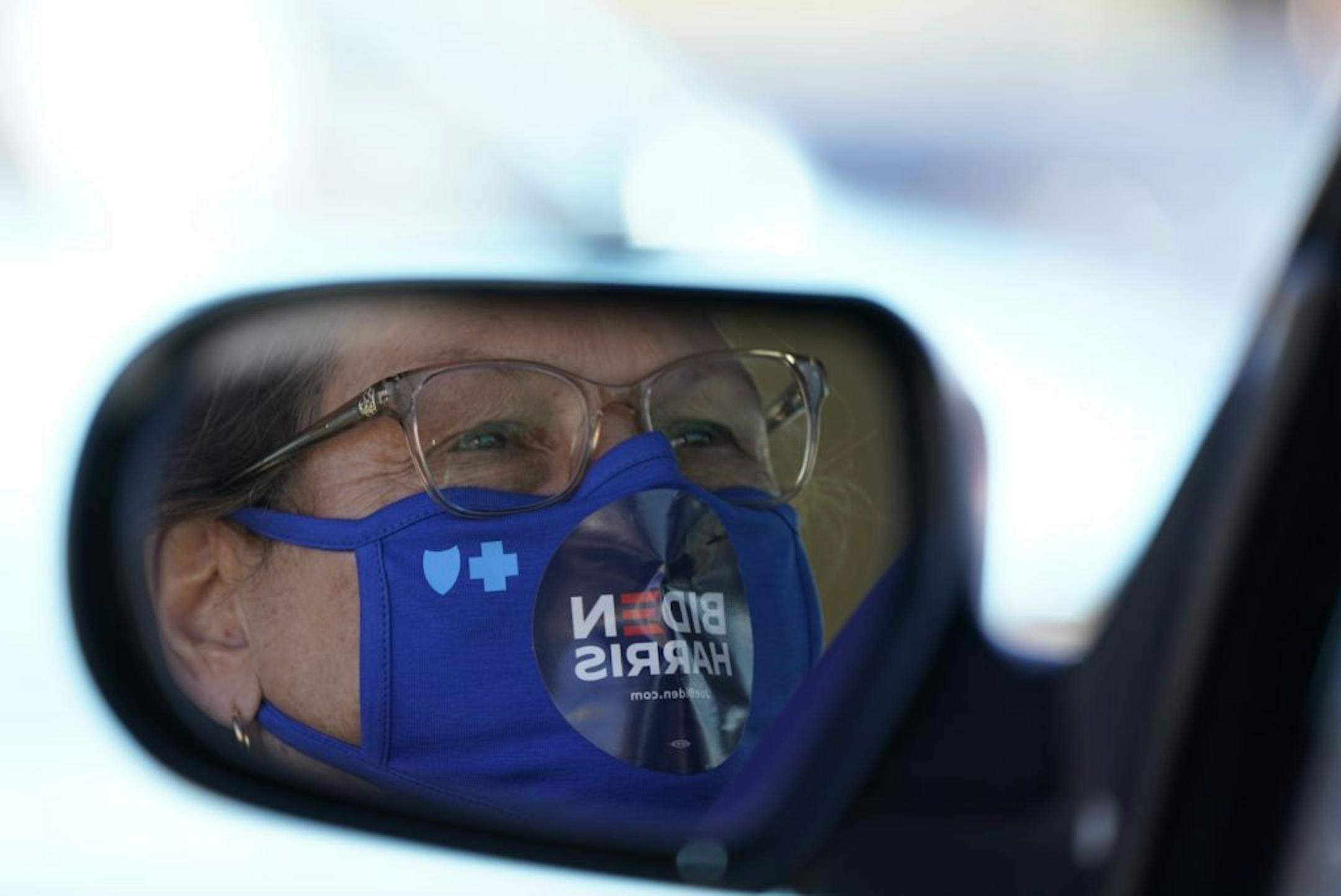 Cindy Garretson of Arden Hills watched the opening program for former Vice President Joe Biden during a drive-in campaign event in Falcon Heights.