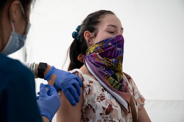 Administering a shot at a community vaccination and testing site in San Francisco on Aug. 1, 2021. 