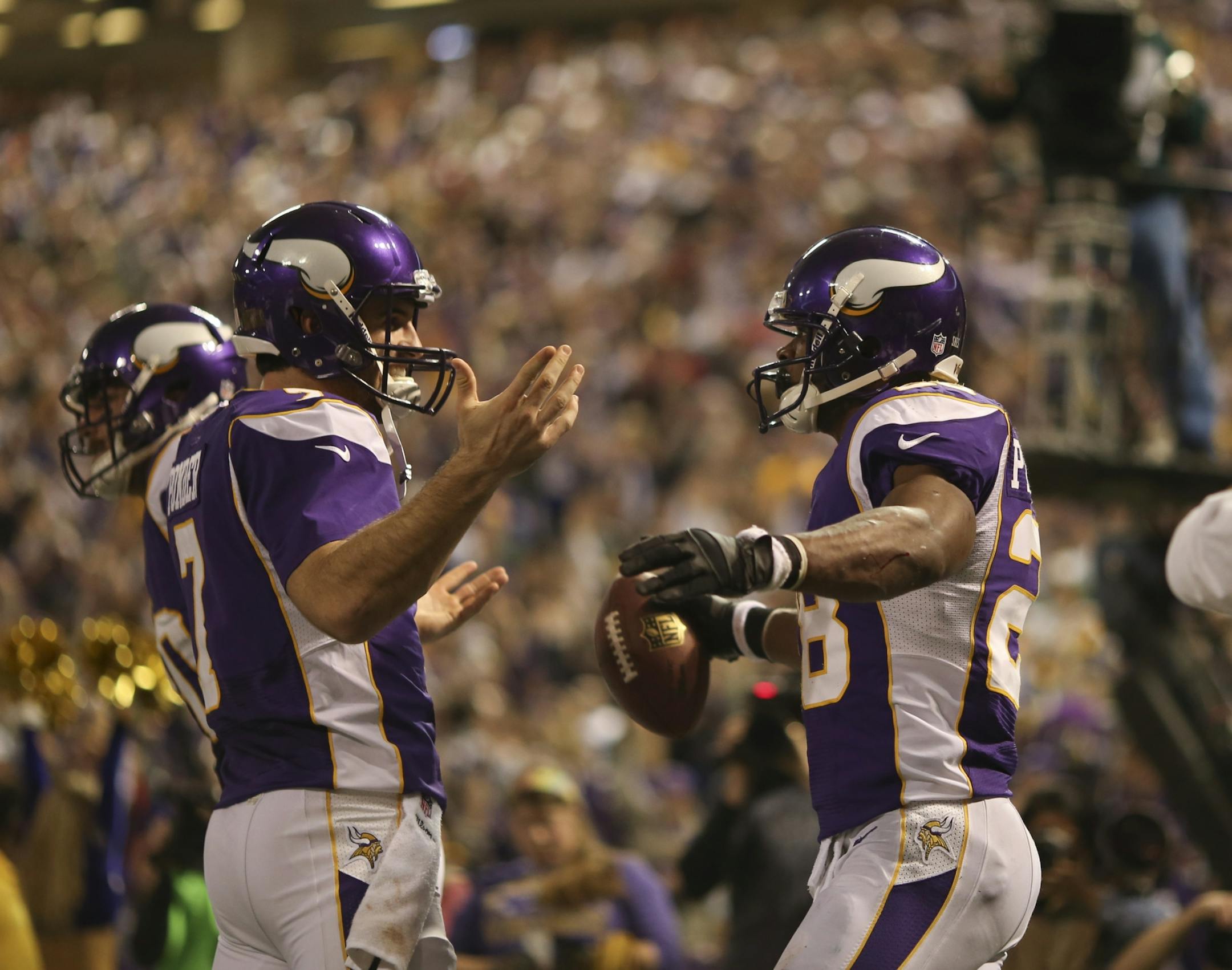 The Minnesota Vikings pulled out a 37-34 win over the Green Bay Packers in an NFL football game Sunday afternoon, December 30, 2012 at Mall of America Field in Minneapolis, Minn. Christian Ponder celebrated with Adrian Peterson after Peterson caught his two yard touchdown pass in the third quarter.