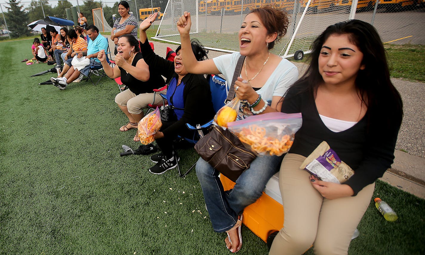 Anna Garcia, left, and Bertha Espinoza, right, cheered on their children&#x2019;s team during a soccer tournament, Saturday, August 29, 2015, at Academy of Holy Angels in Richfield.