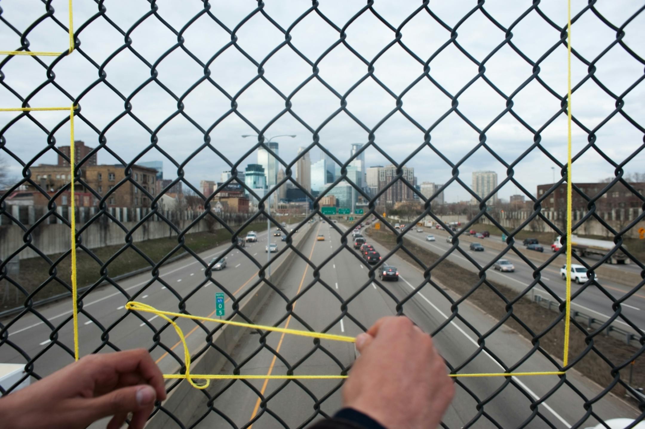 Eric Reiger applies his "HOTTEA" yarn tag to the Franklin Ave. I-35 overpass on April 8th in Minneapolis, Minn.