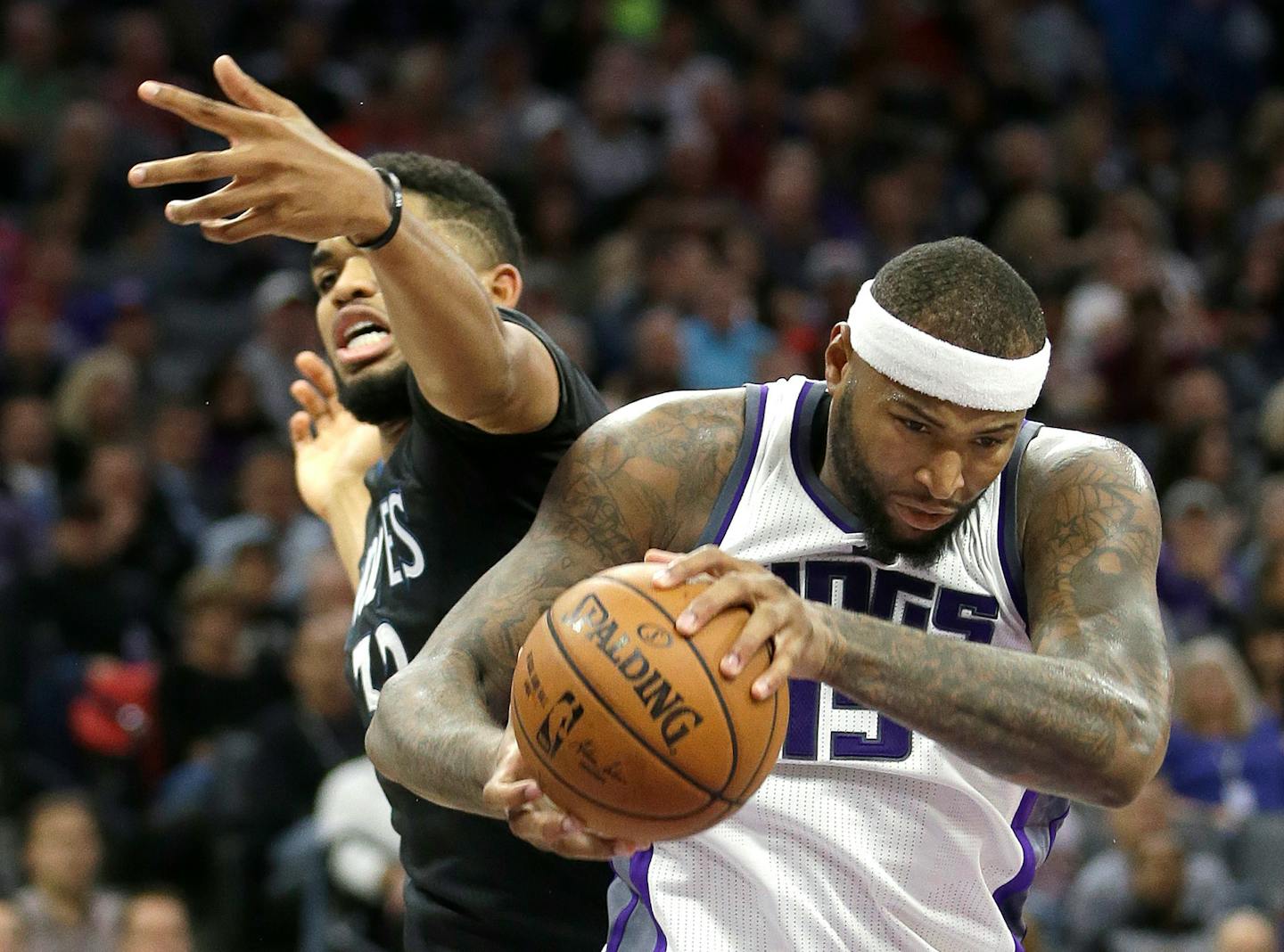 Kings center DeMarcus Cousins, right, grabbed a rebound from Timberwolves center Karl-Anthony Towns during the second quarter Saturday.