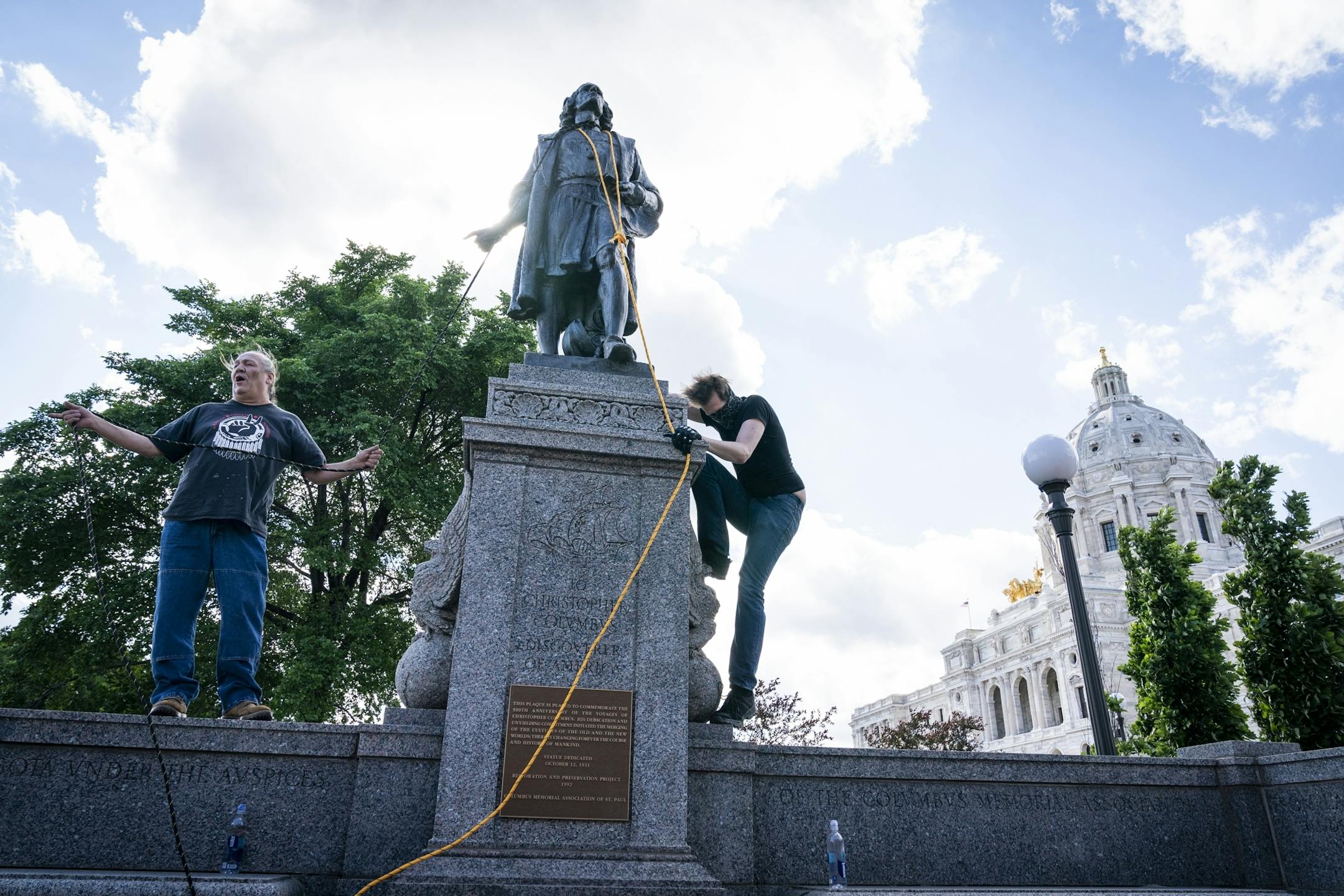 Activists put ropes around the neck of the Christopher Columbus statue, preparing to pull it down.