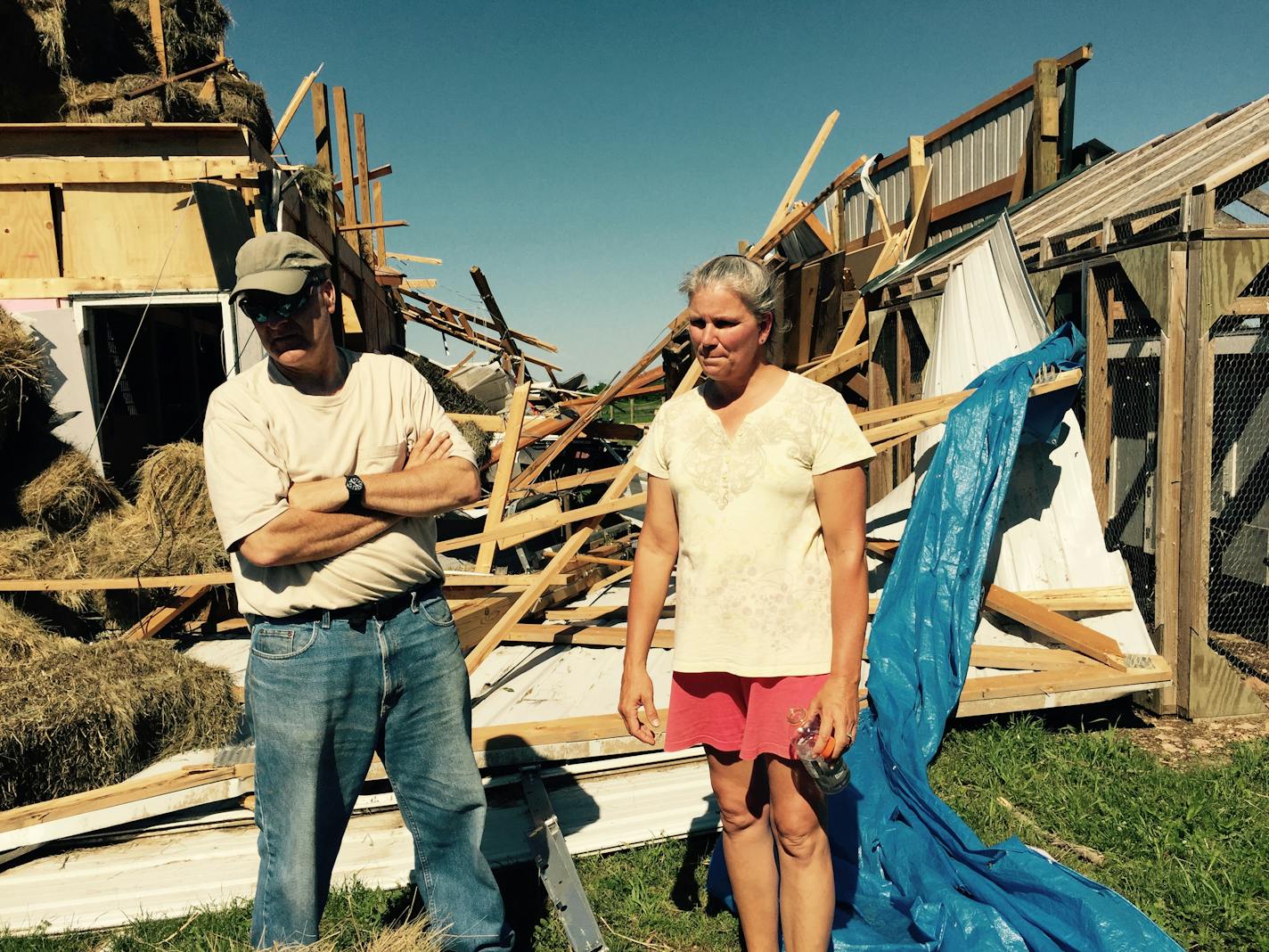 Benjamin and Patty Falk stand outside their destroyed barn in Hollywood Township, near where a tornado touched down overnight. Their house also sustained major damage.