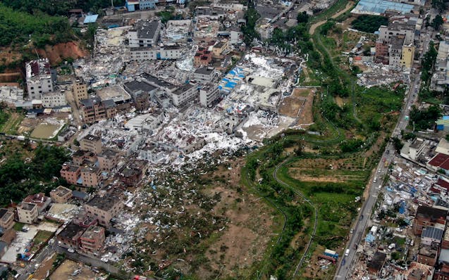 In this photo provided by China's Xinhua News Agency, an aerial view shows damaged buildings in the aftermath of a tornado in Guangming Village of Zho