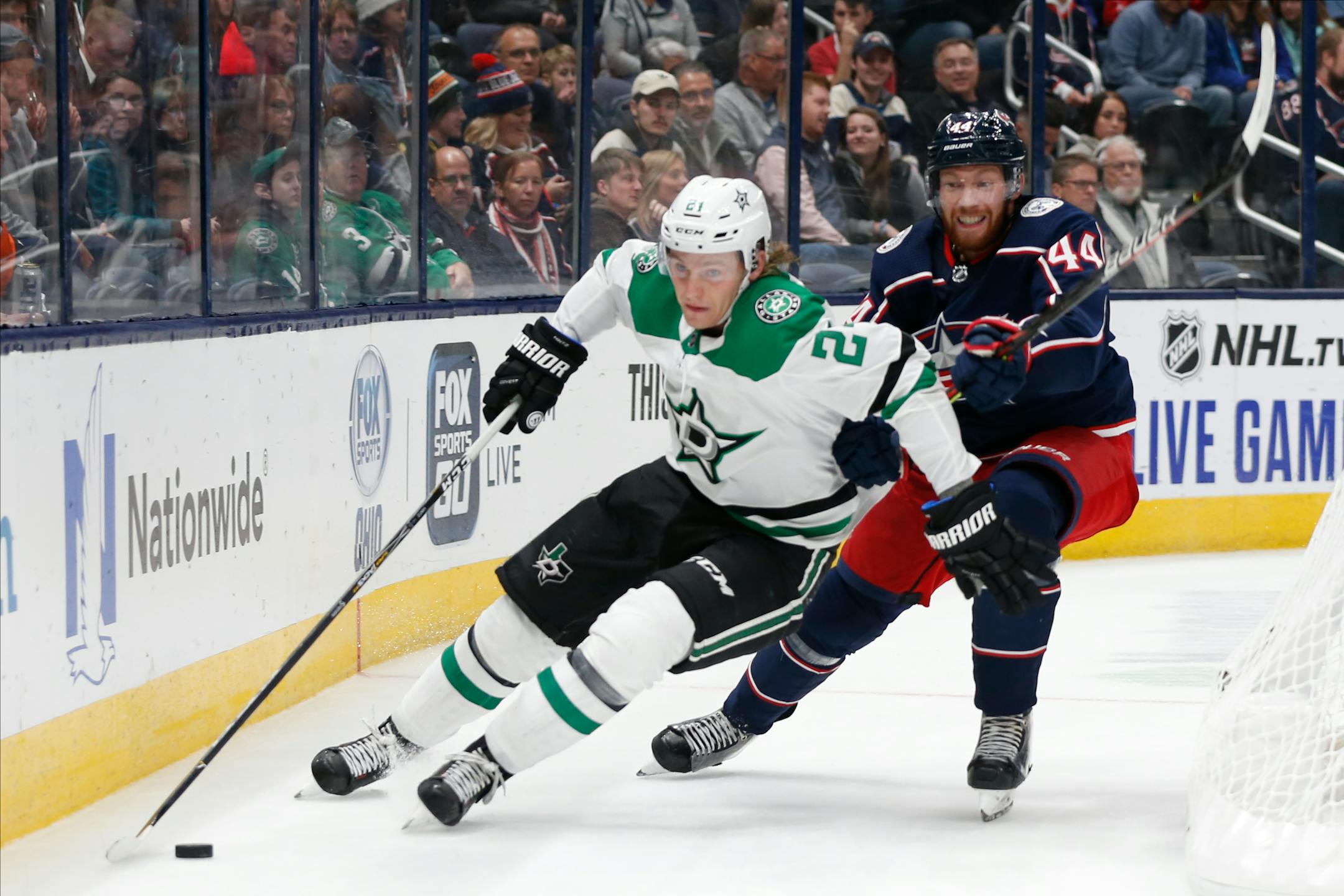 Dallas Stars' Roope Hintz, left, of Finland, carries the puck behind the net as Columbus Blue Jackets' Vladislav Gavrikov, of Russia, defends during the third period of an NHL hockey game Wednesday, Oct. 16, 2019, in Columbus, Ohio. The Blue Jackets won 3-2. (AP Photo/Jay LaPrete)