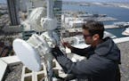 Webpass technician Adam Larnach installs an upgraded millimeter wave radio on the roof top of a high rise condo unit in downtown San Diego. The upgrad