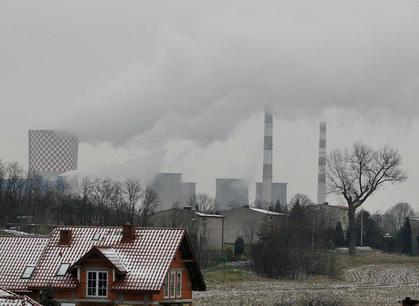 In this Nov. 21, 2018 photo smoke billows from chimney stacks of the heating and power plant in Bedzin, near Katowice, southern Poland. Katowice, in the southern coal mining region, will host global climate summit Dec.2-14.