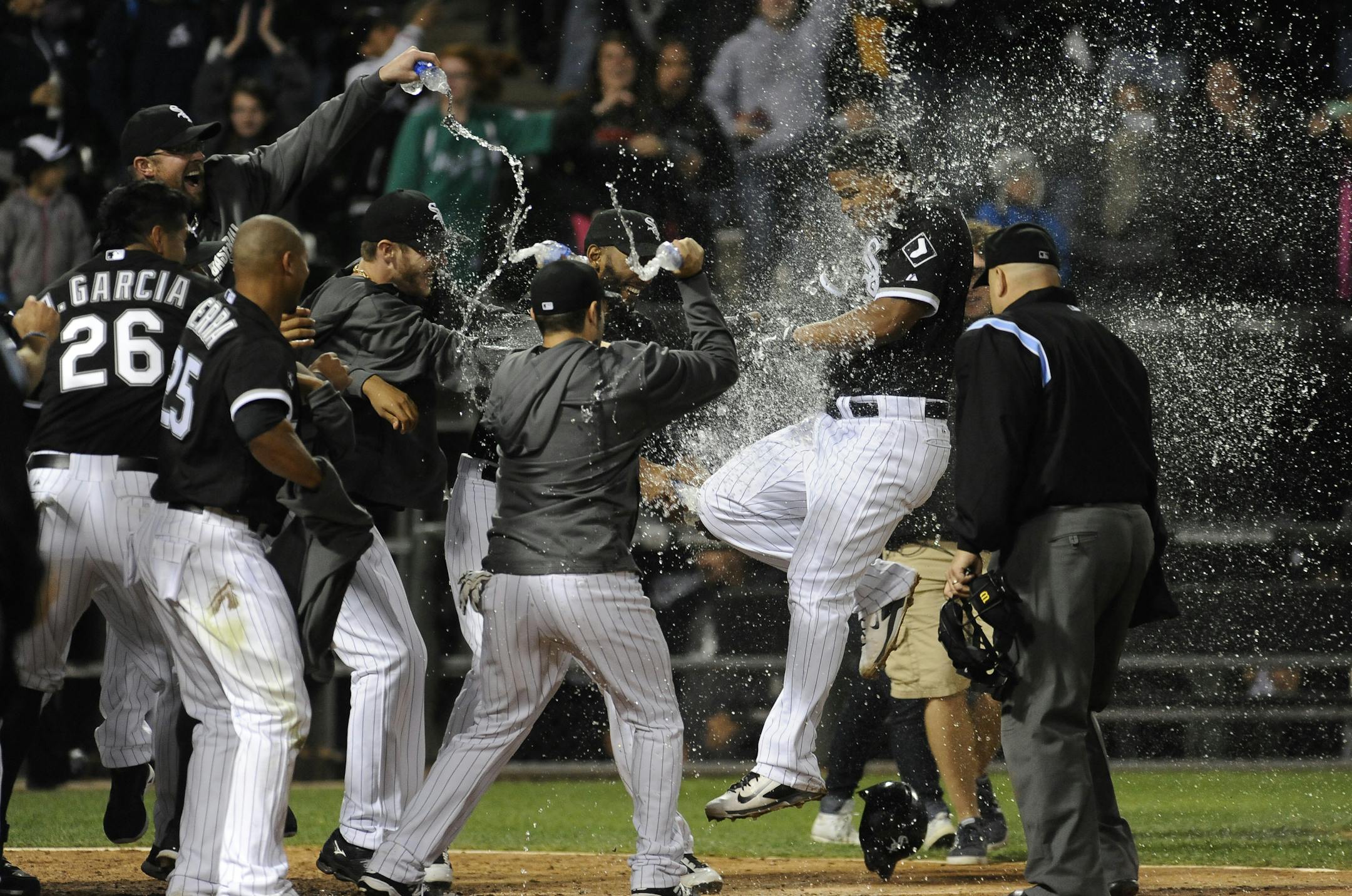 Chicago White Sox's Dayan Viciedo is doused with water by teammates at home plate after he hit a two-run walkoff RBI to beat the Minnesota Twins 7-6 in the second game of a baseball doubleheader in Chicago on Saturday, Sept. 13, 2014. (AP Photo/Matt Marton)