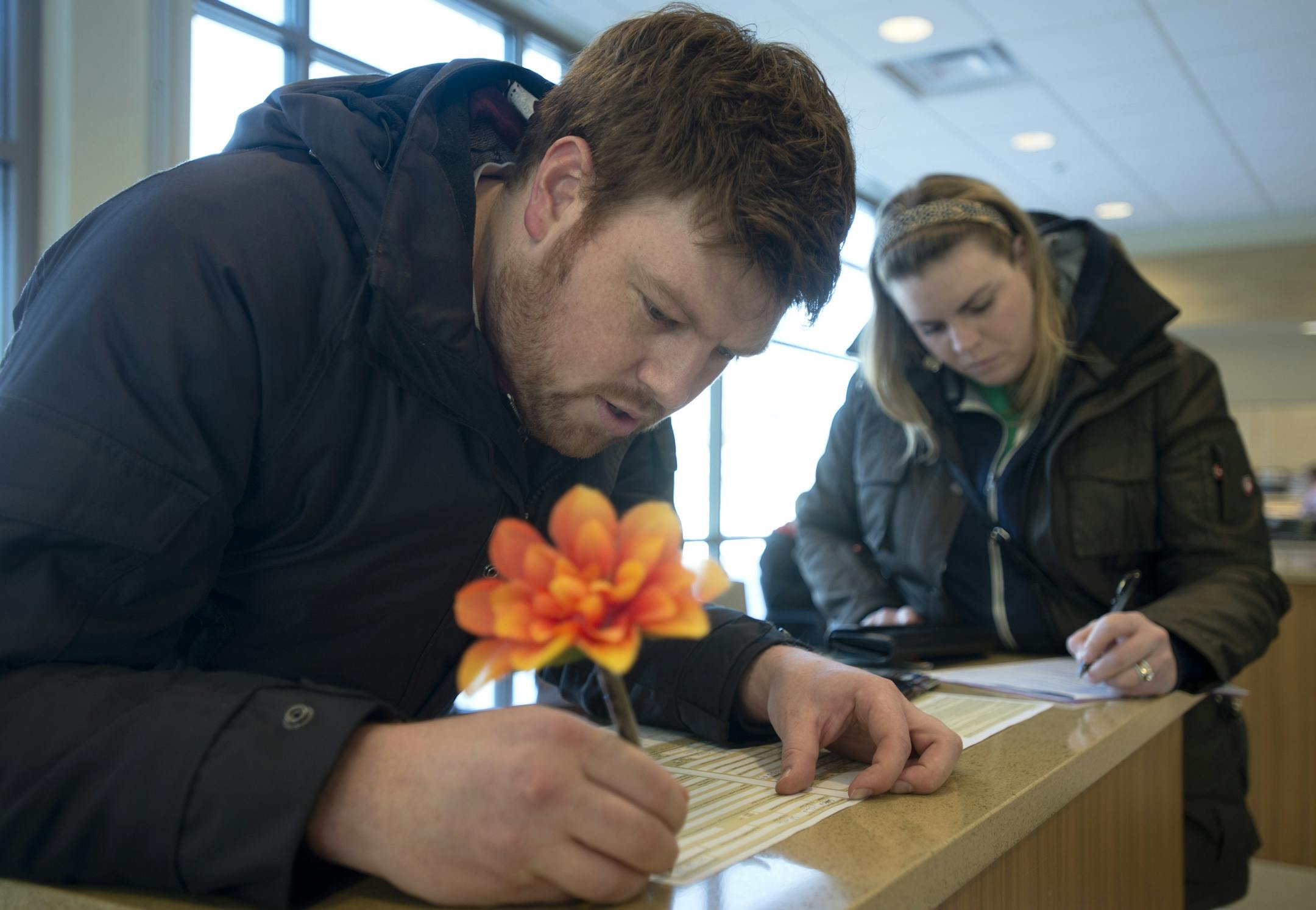 Minneapolis residents Chad Gannon, left, and Andrea Gannon fill out their information to get their passports renewed at Richfield City Hall on Friday, January 31, 2014. The Gannon's tried getting their passports renewed in Edina before finding out they stopped processing passports. ] (AMANDA SNYDER/ Star Tribune)