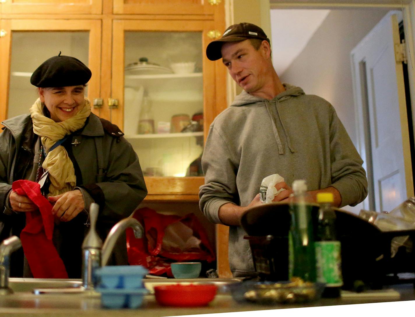 Dennis Teske, 44, a veteran who spent three years on the streets and sleeping in sub-zero temperatures before going through HOMES court, at his new Minneapolis south apartment. The court was instrumental in helping him attain sobriety and an apartment, keys to which he pulled out of his pocket last month in the courtroom to thunderous cheers. Here, Teske, right, chats with Lynne Kincaid, St. Stephen's Human Services case manager, during a visit by Kincaid.] (DAVID JOLES/STARTRIBUNE)djoles@startr