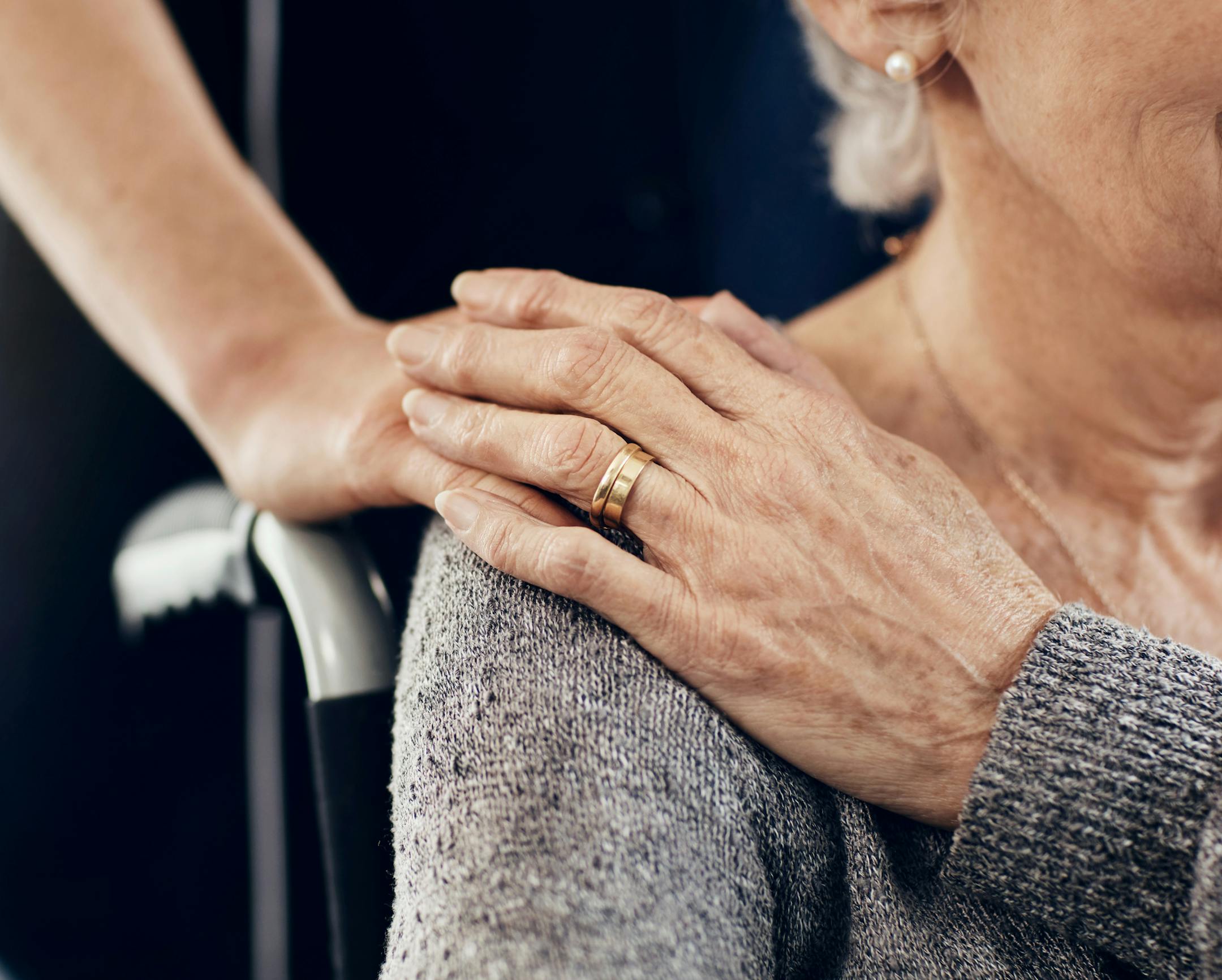 Cropped shot of a female caregiver comforting a senior woman