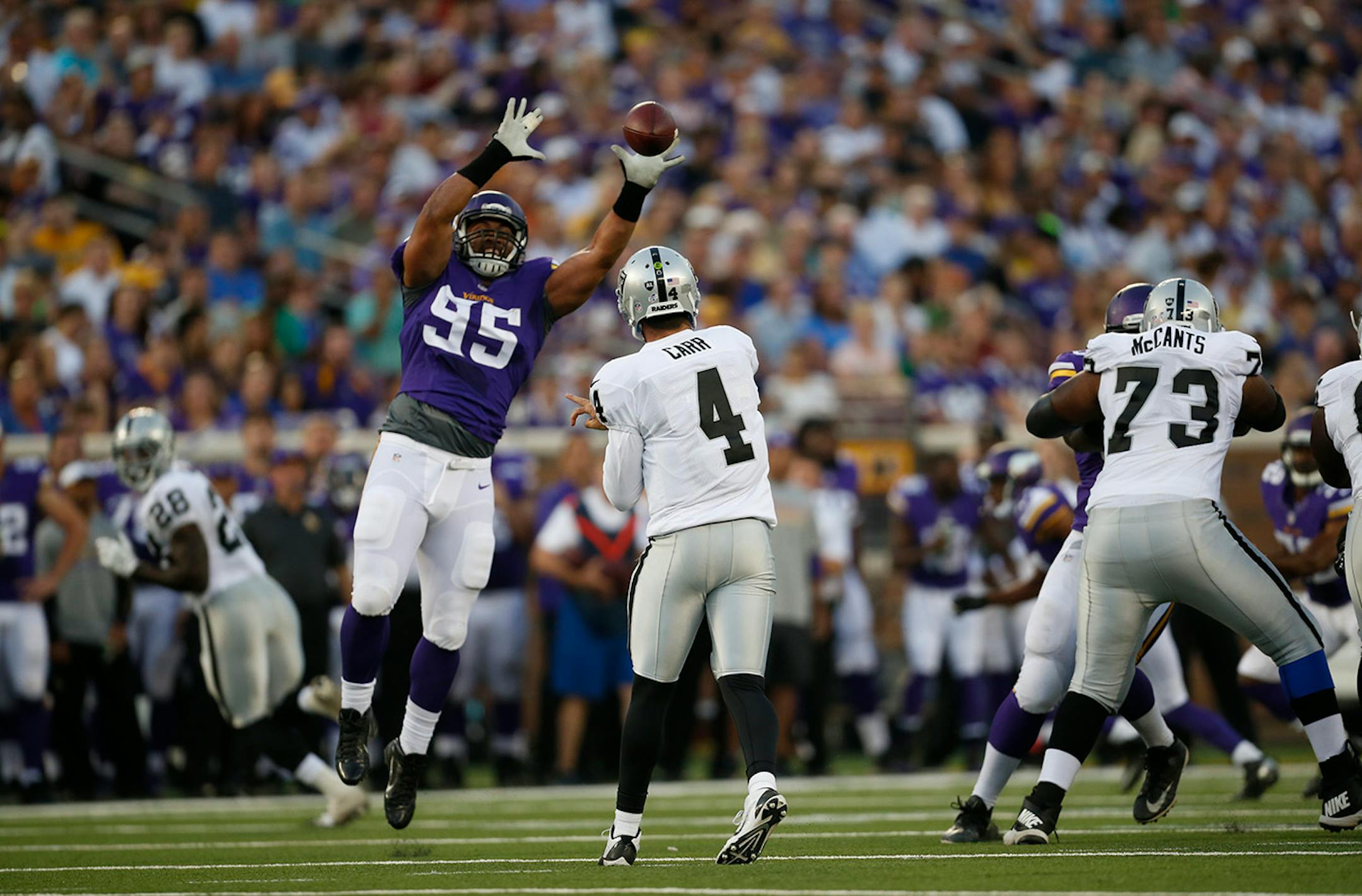 Minnesota Vikings defensive end Scott Crichton (95) nearly deflected a second quarter pass by Oakland Raiders quarterback Derek Carr (4) Thursday evening.