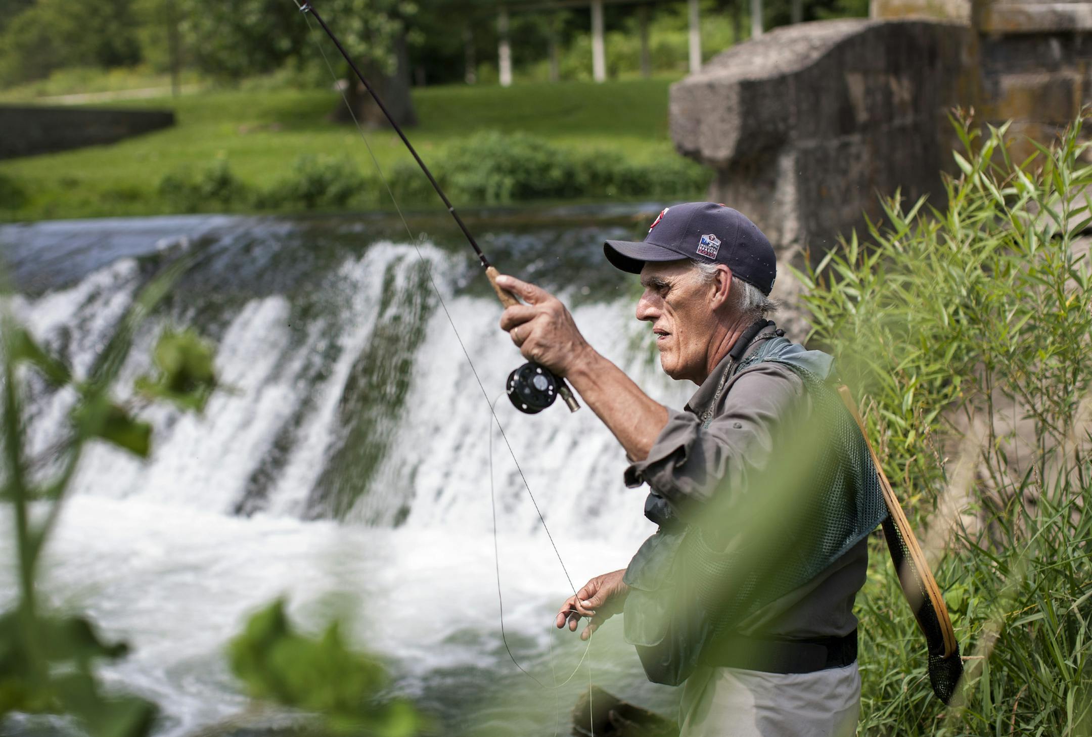 National Trout Center program coordinator Rich Enochs fly fishes in Trout Run Creek at Bucksnort Park in Fillmore County in Southeast Minnesota July 10, 2014. (Courtney Perry/Special to the Star Tribune)