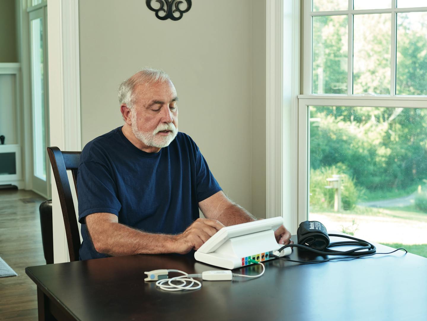 A person demonstrates what it would be like to use the device at home for a patient who might need to take a blood pressure reading with the device as part of the test.(Provided photo)