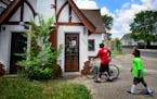 Anthony Theba and his son Aten-Wa Theba at the building Anthony hopes to turn into a bike shop. ] GLEN STUBBE * gstubbe@startribune.com Friday, June 2