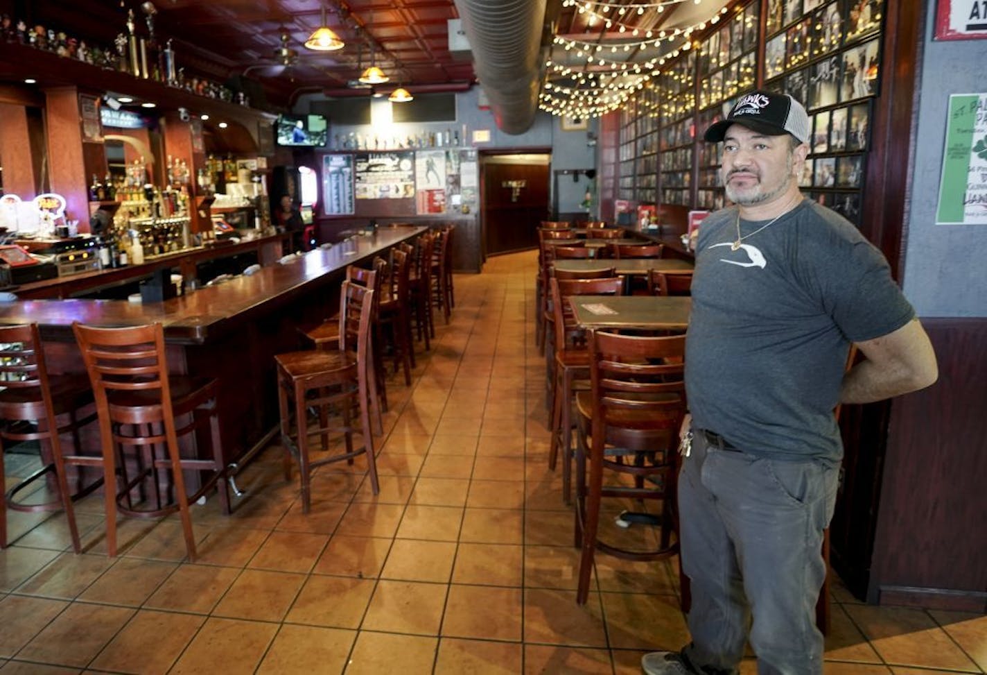 Hawk Sullivan, owner of Hawks Bar & Grill on State Street is photographed Monday, March 16, 2020 over the lunch hour in his empty restaurant in Madison, Wisc. Wisconsin Gov. Tony Evers on Monday ordered a ban on all gatherings of more than 50 people, a dramatic move in line with federal recommendations and as other states took similar action to stop the spread of the new coronavirus.