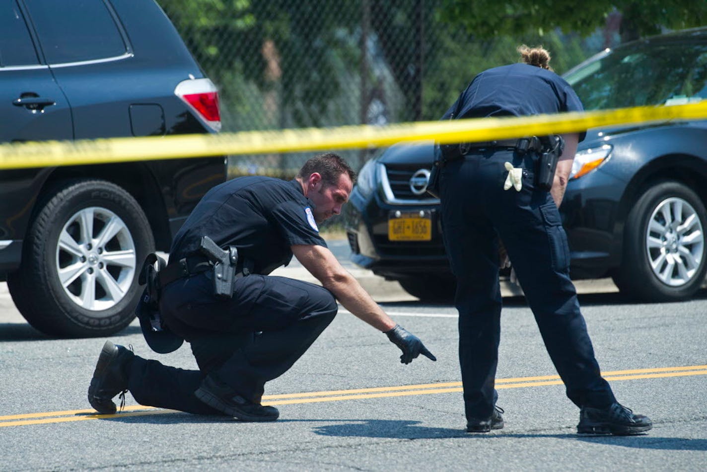 Crime scene investigators search for evidence at the scene of the shooting in Alexandria, Va., Wednesday, June 14, 2017.