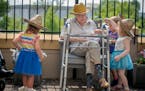 Children from the TowerLight Child Care Center helped Joan Johnson, from the TowerLight Memory Care Unit, water plants as part of their multigeneratio