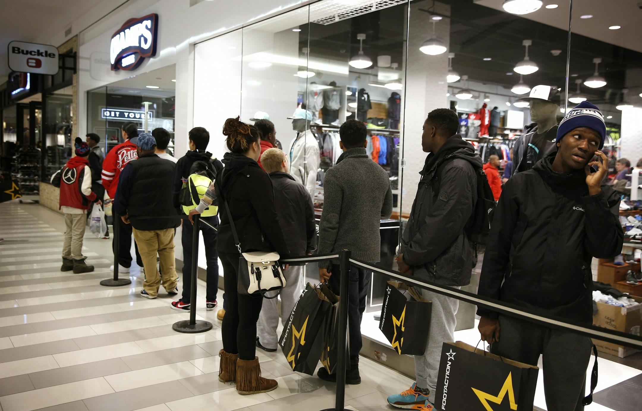 Shoppers line up outside of Champs Sports for the newest Nike Air Jordan sneaker release on Black Friday at Mall of America in Bloomington on Friday, November 28, 2014.