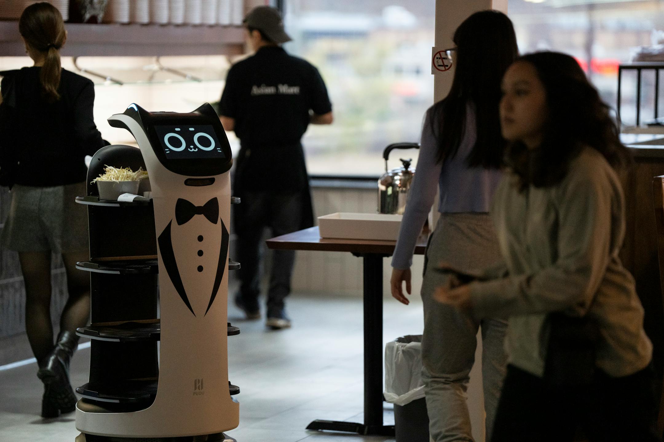 Robot servers bring food to tables at Hot Pot City at a soft opening for the new Asia Mall.