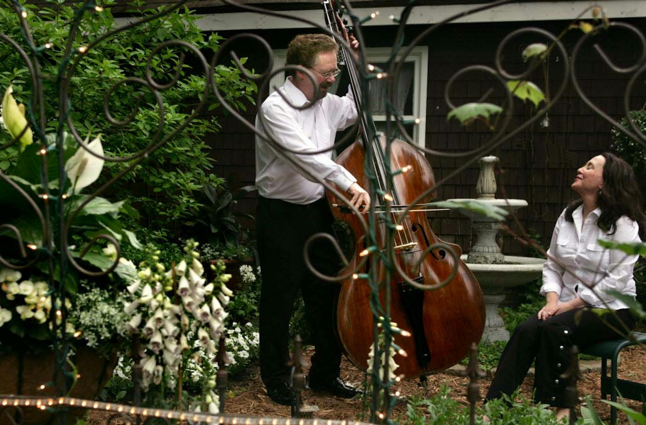 Musician Bill Schrickel serenades his wife, Pamela Hill Nettleton, in their romantic Minneapolis garden.