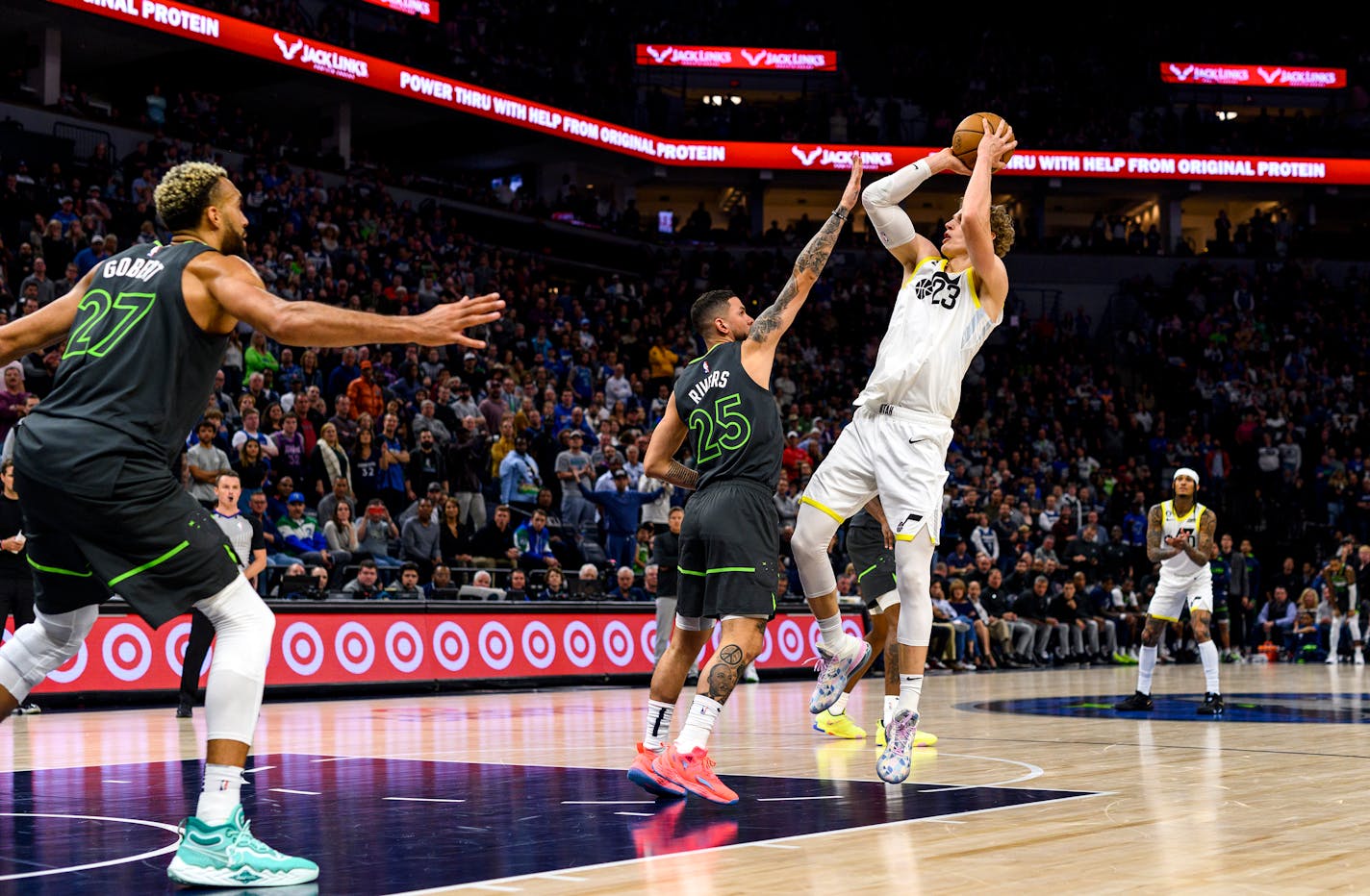 Lauri Markkanen puts up a shot over the Timberwolves' Austin Rivers to take a two-possession lead in overtime at Target Center on Friday