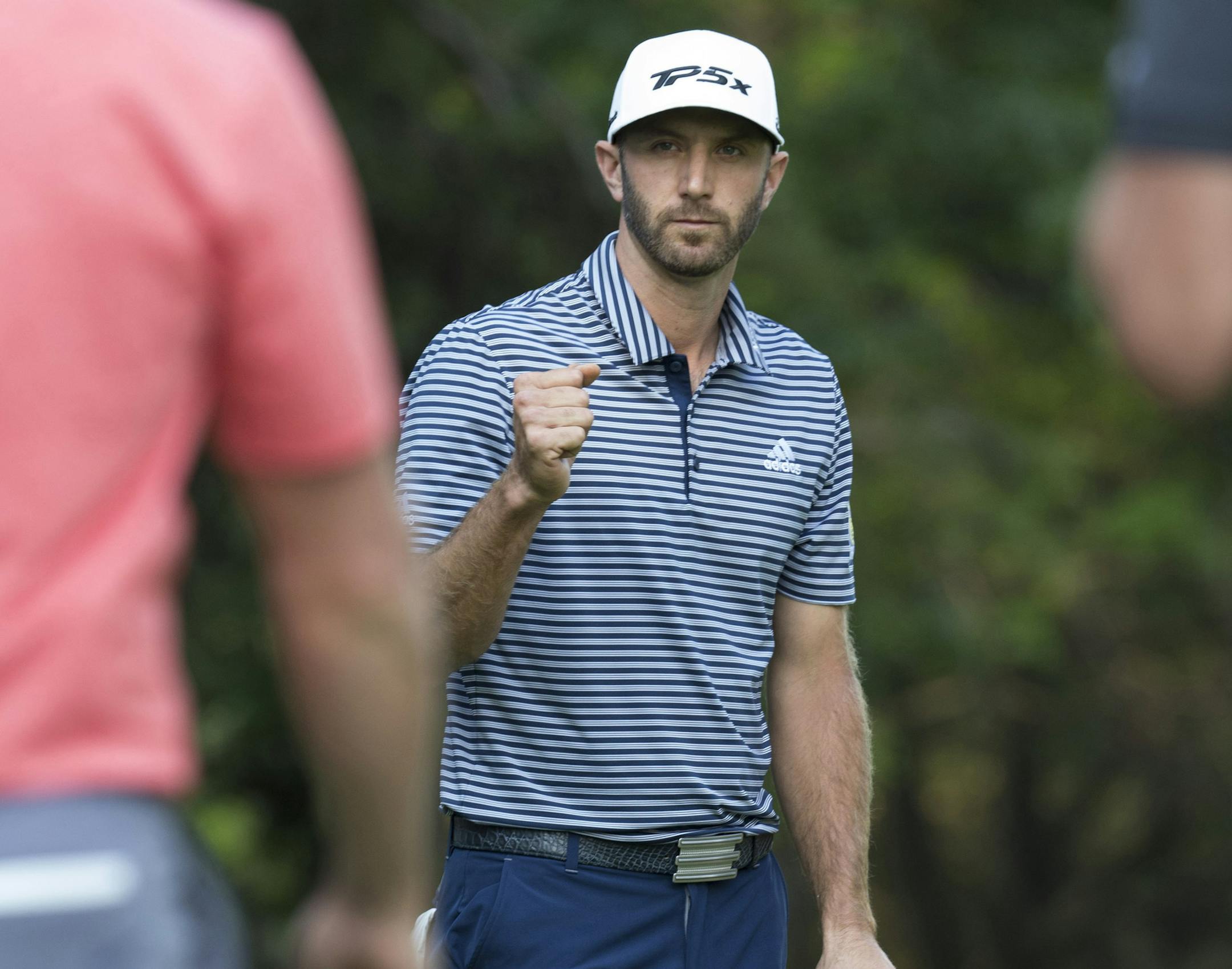 U.S. golfer Dustin Johnson celebrates winning the Mexico Championship trophy at the Chapultepec Golf Club in Mexico City, Sunday, Feb. 24, 2019. (AP Photo/Christian Palma)