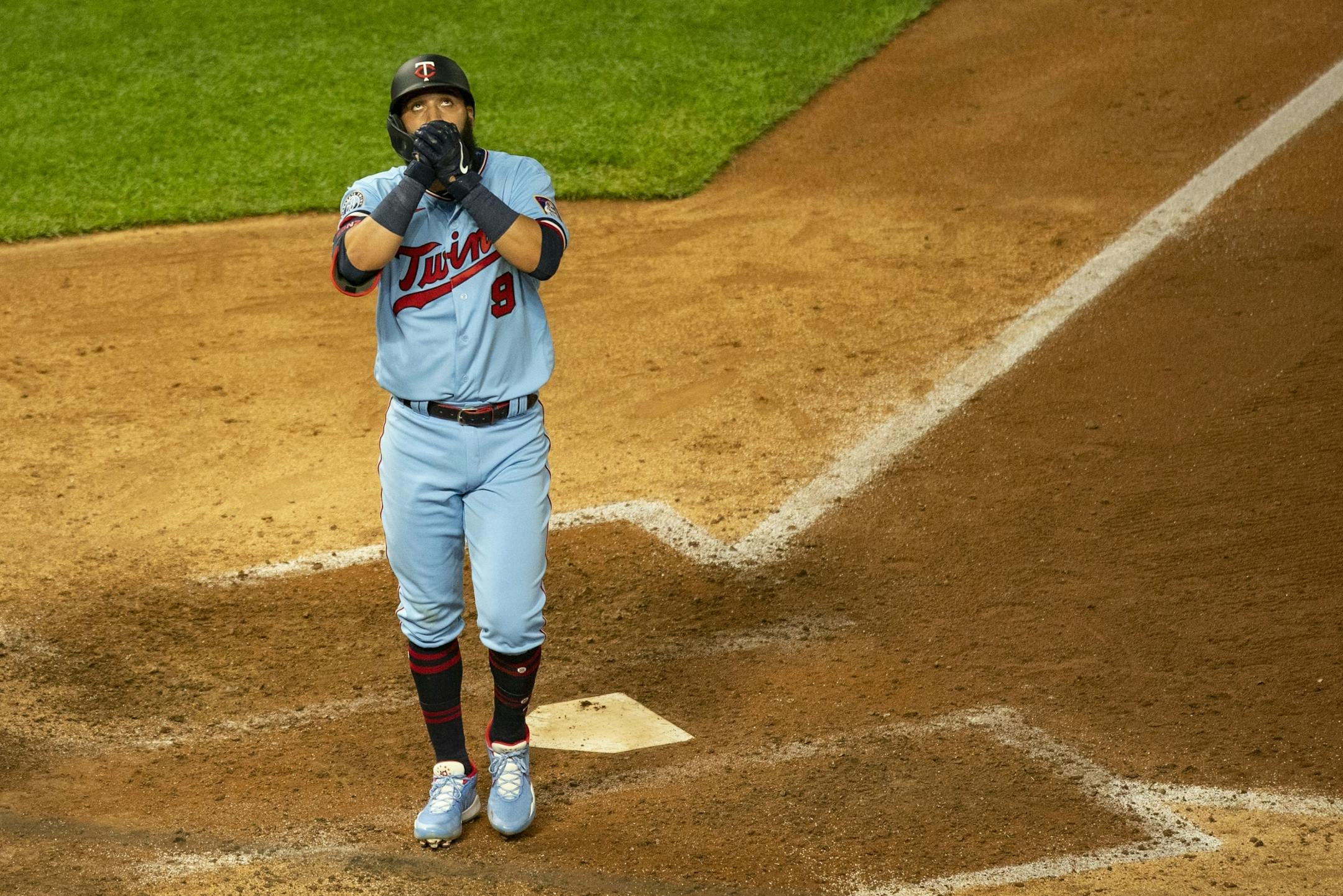 Minnesota Twins catcher Mitch Garver (8) kissed his hands while crossing home plate after hitting a solo home run in the bottom of the ninth inning.