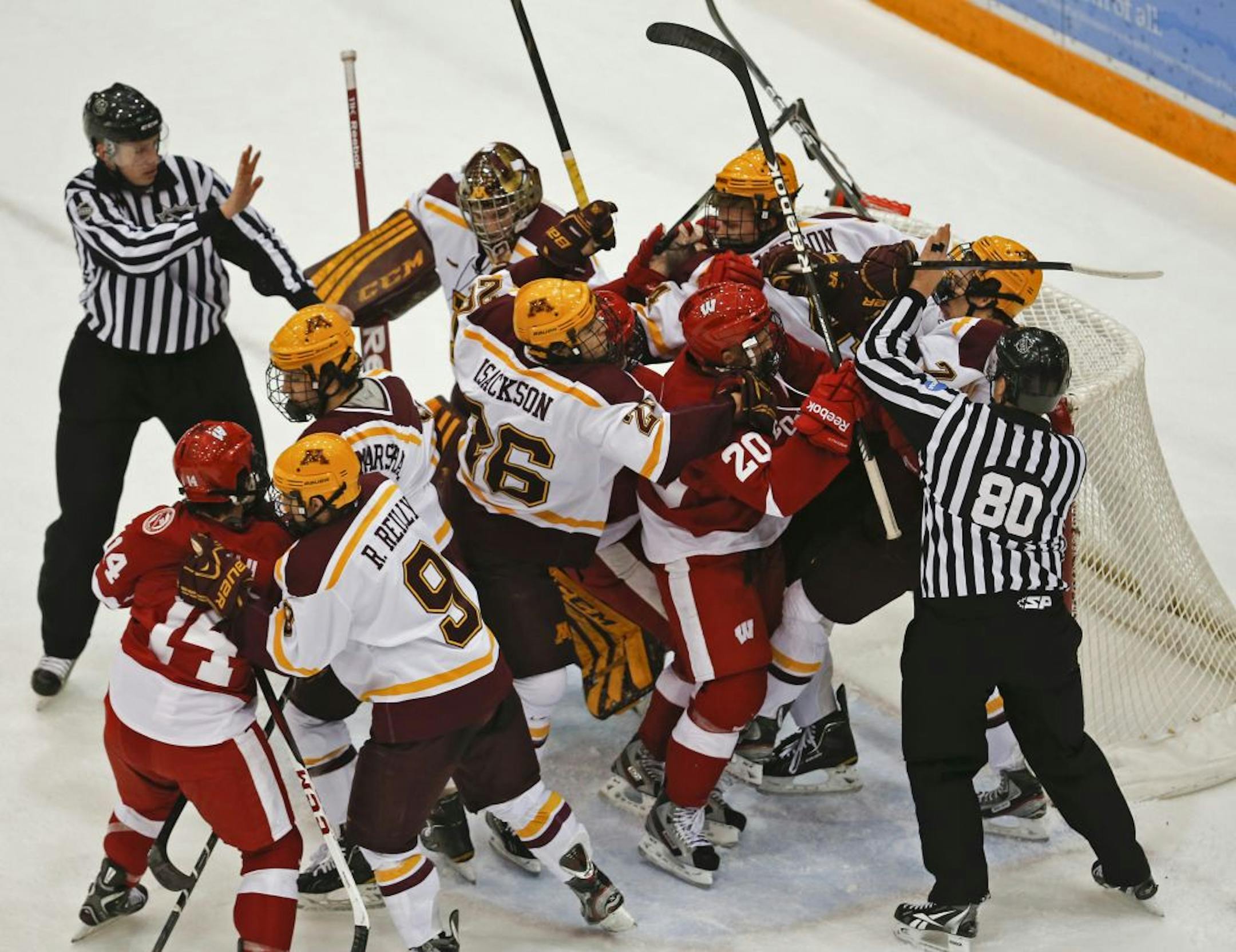 Minnesota and Wisconsin players mixed it up near the Gophers net during first period action.