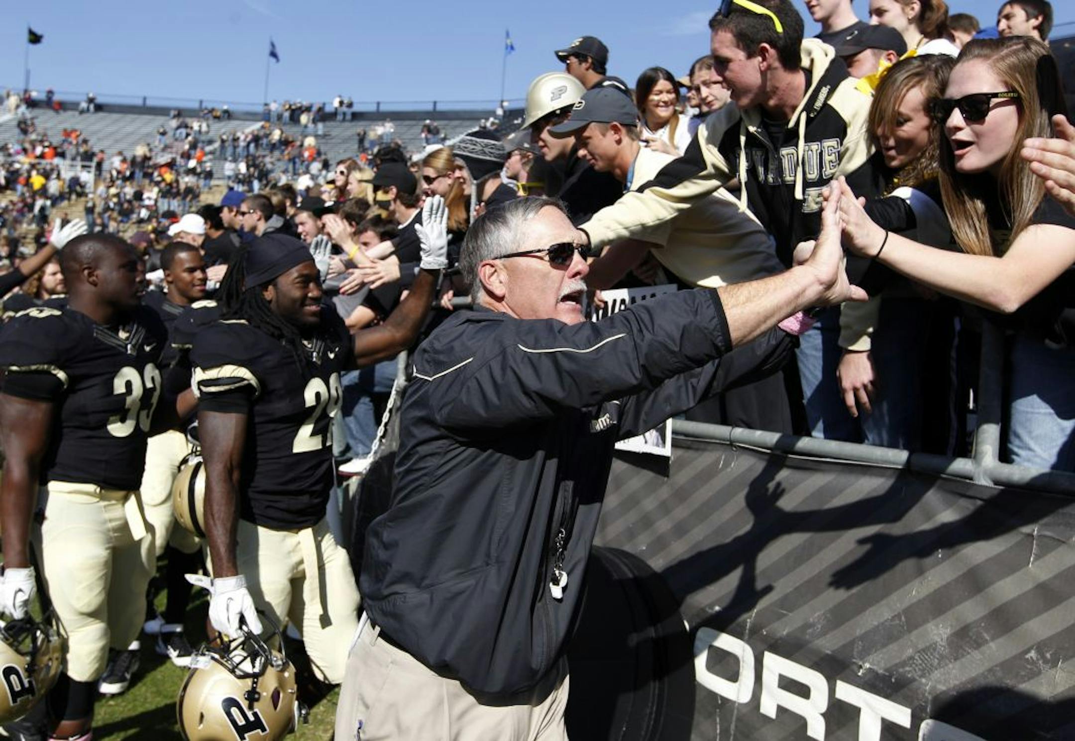 Purdue head coach Danny Hope celebrates with fans following a 21-14 win over Illinois in an NCAA college football game Saturday, Oct. 22, 2011, in West Lafayette, Ind.