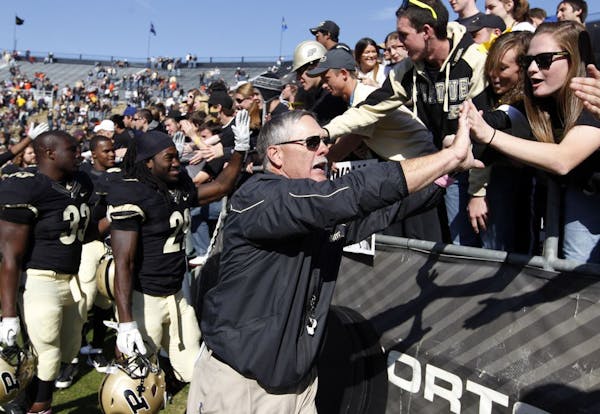 Purdue head coach Danny Hope celebrates with fans following a 21-14 win over Illinois in an NCAA college football game Saturday, Oct. 22, 2011, in Wes