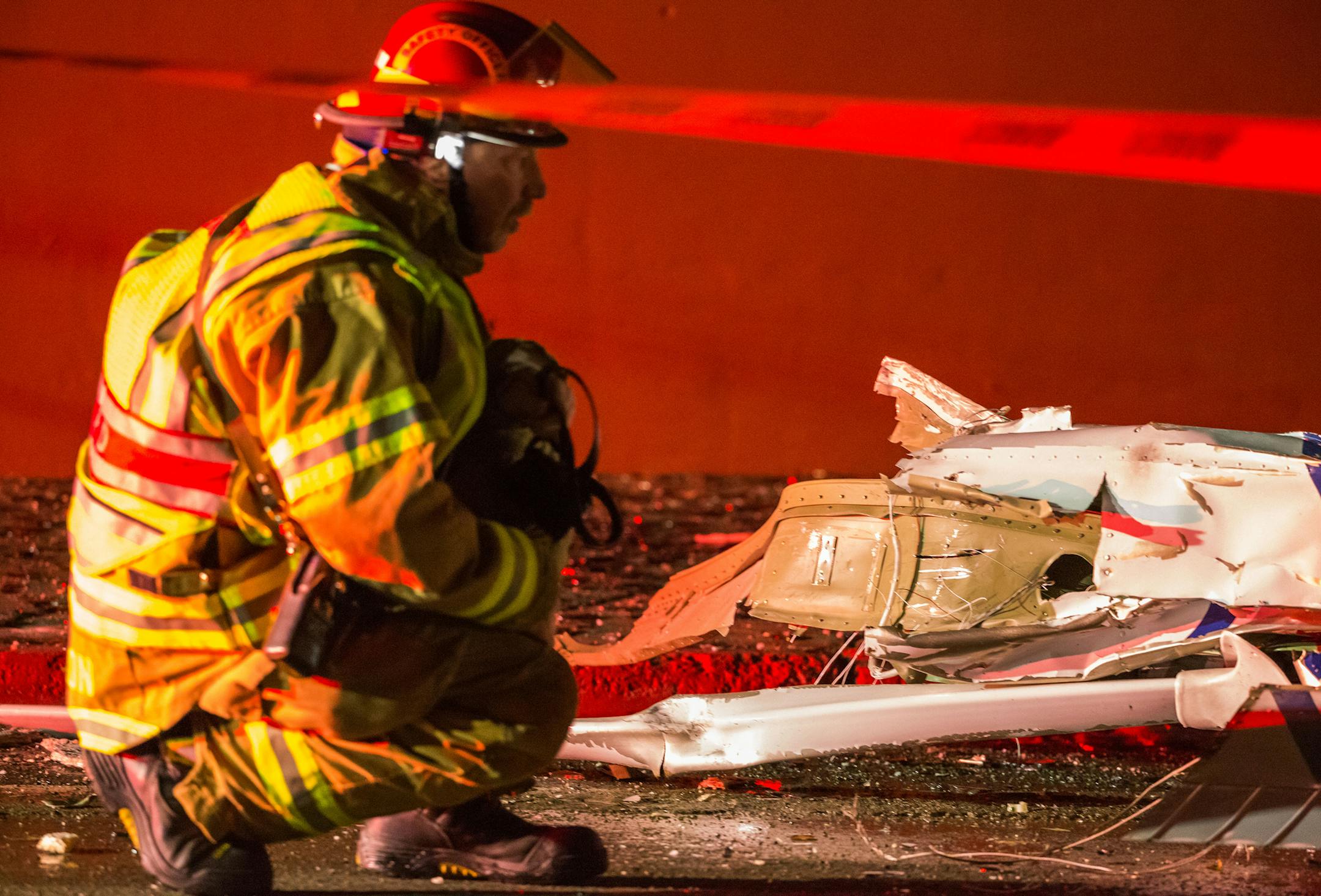 Anchorage Fire Department personnel secure the wing of a Civil Air Patrol Cessna 172S plane after it crashed into two buildings in downtown Anchorage, Alaska, early Tuesday morning, Dec. 29, 2015. Civil Air Patrol officials identified 1st Lt. Doug Demarest as the person killed in the crash, and said the flight was not sanctioned by the agency. (Loren Holmes/Alaska Dispatch News/TNS) ORG XMIT: 1178637
