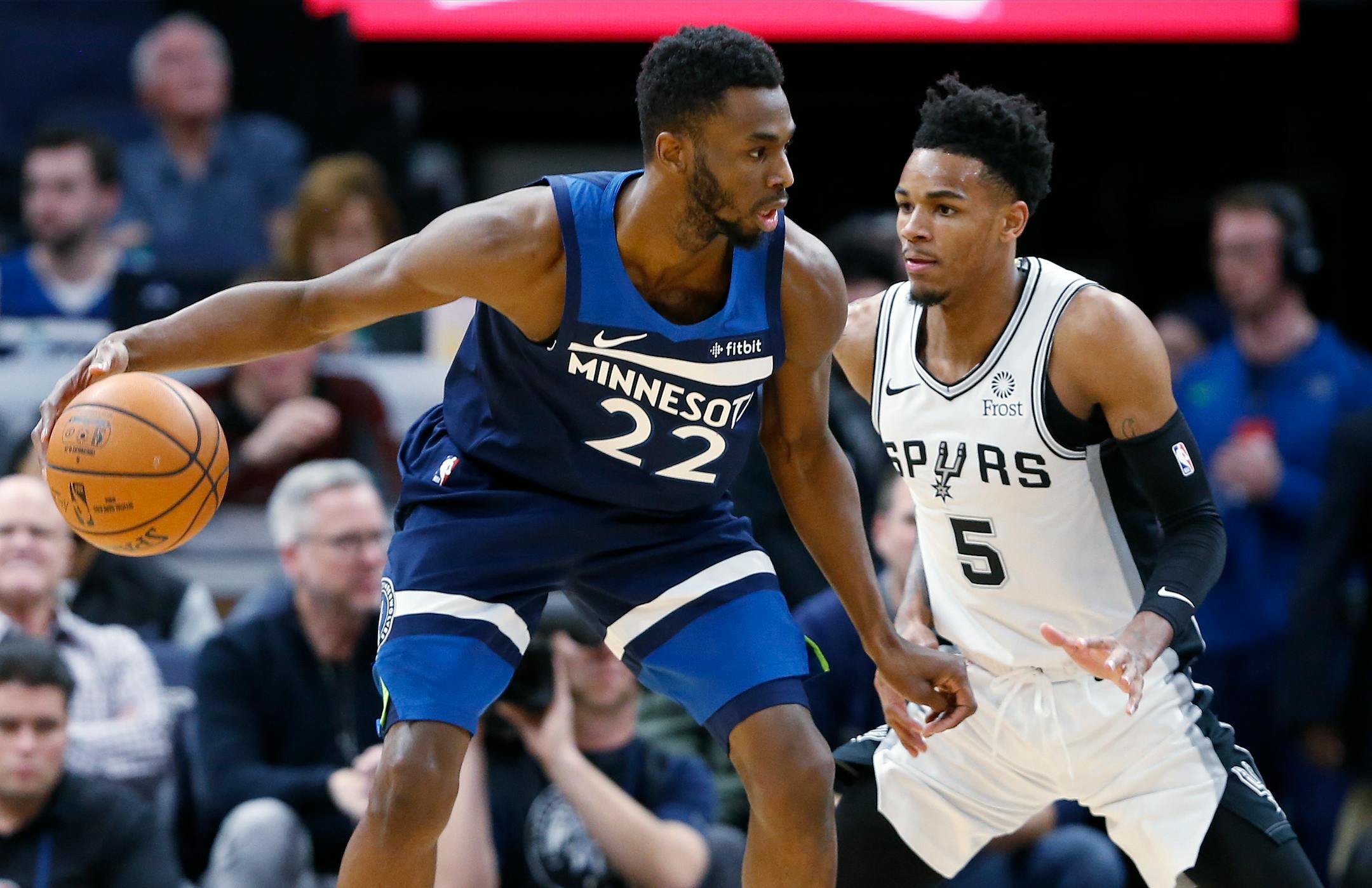 The Timberwolves' Andrew Wiggins, left, drives around San Antonio Spurs' Dejounte Murray in the first half.