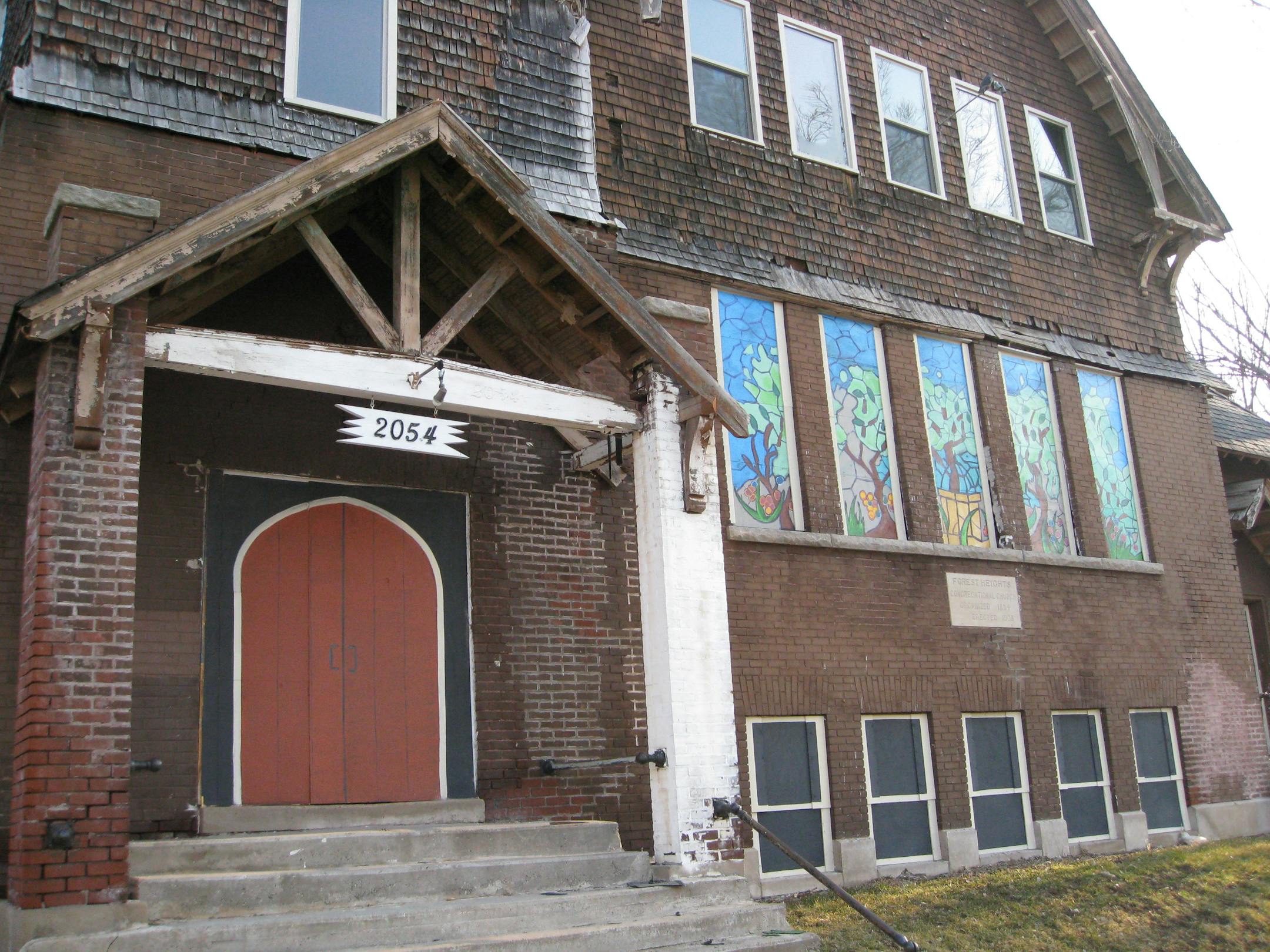 Photo by Steve Brandt/Star Tribune -- An alternative boarding experiment in the Jordan neighborhood is using painted boards to camouflage the status of several boarded buildings.This former church building has painted boards mimicking stain glass windows, with a row of more prosacic windows that are boarded and camouflaged below, and its original winodws above.