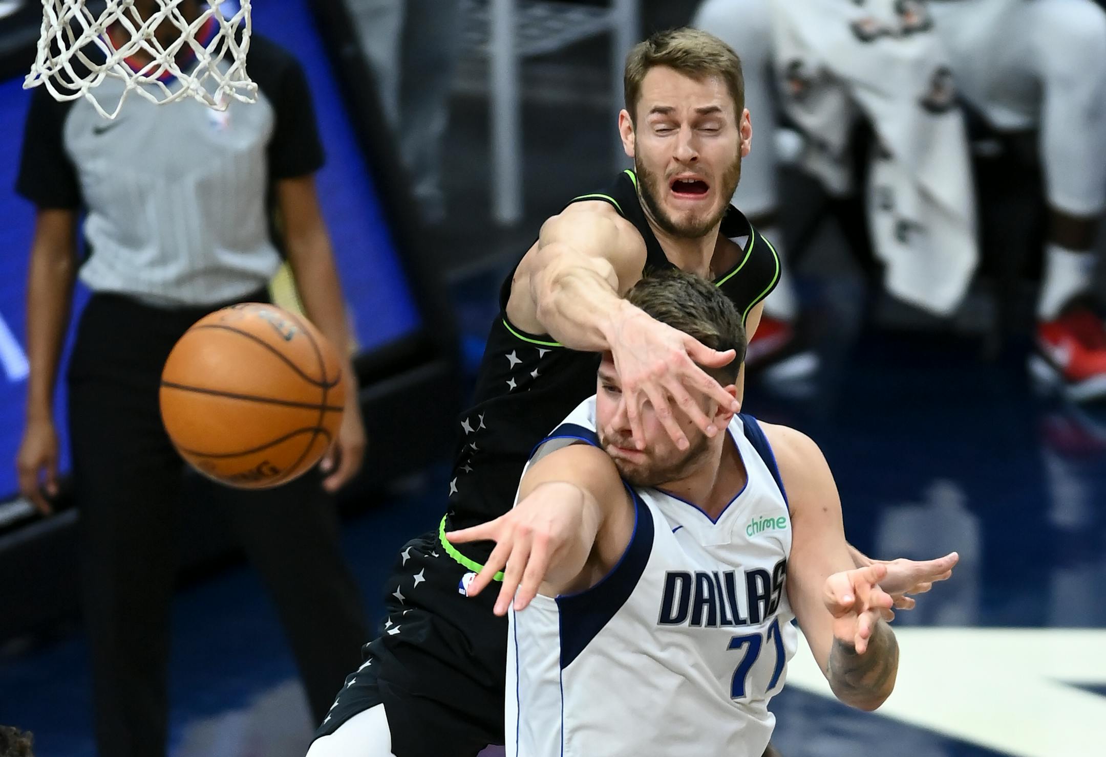 Minnesota Timberwolves forward Jake Layman (10) tried to interrupt a pass by Dallas Mavericks guard Luka Doncic (77) in the first half.