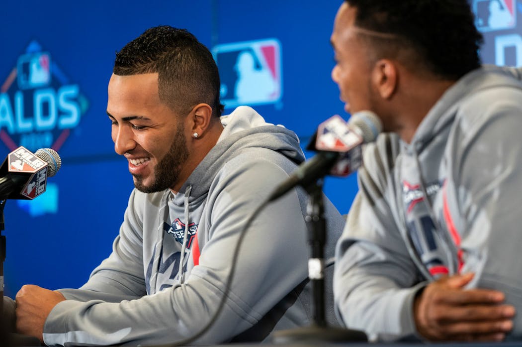 Eddie Rosario (left) talked to reporters before the 2019 playoffs.