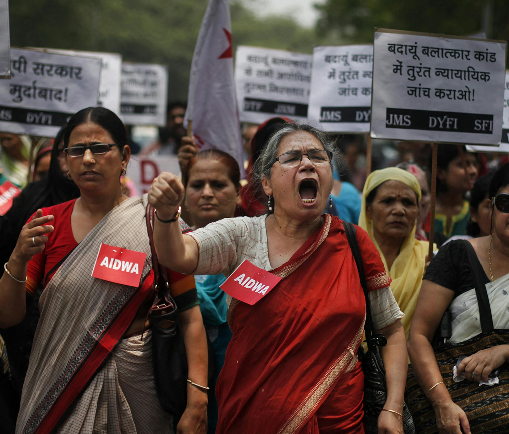FILE- In this Saturday, May 31, 2014 file photograph, members of the All India Democratic Women's Association (AIDWA) shout slogans during a protest against the gang rape of two teenage girls, in New Delhi, India. Beyond highlighting the rampant sexual violence in India, last week‚Äôs horrific crime is drawing attention to a glaring and fundamental problem across the country that threatens women‚Äôs safety: the lack of toilets. The placard reads 'Arrest all accu