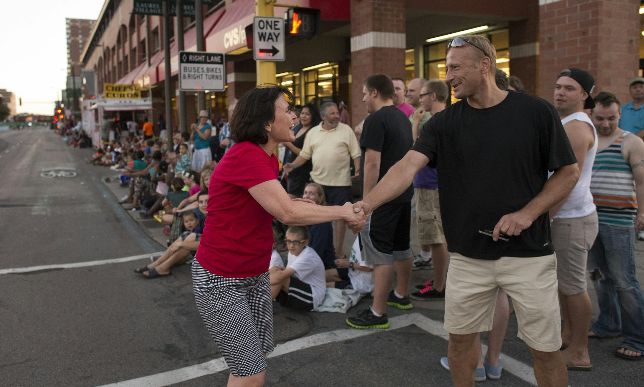 Minneapolis mayor Betsy Hodges jogged the Torchlight Parade route shaking as as many hands as possible. ] CenterPoint Energy Torchlight Parade is the second flagship event of the 75th Minneapolis Aquatennial. DAVIDBREWSTER/STAR TRIBUNE