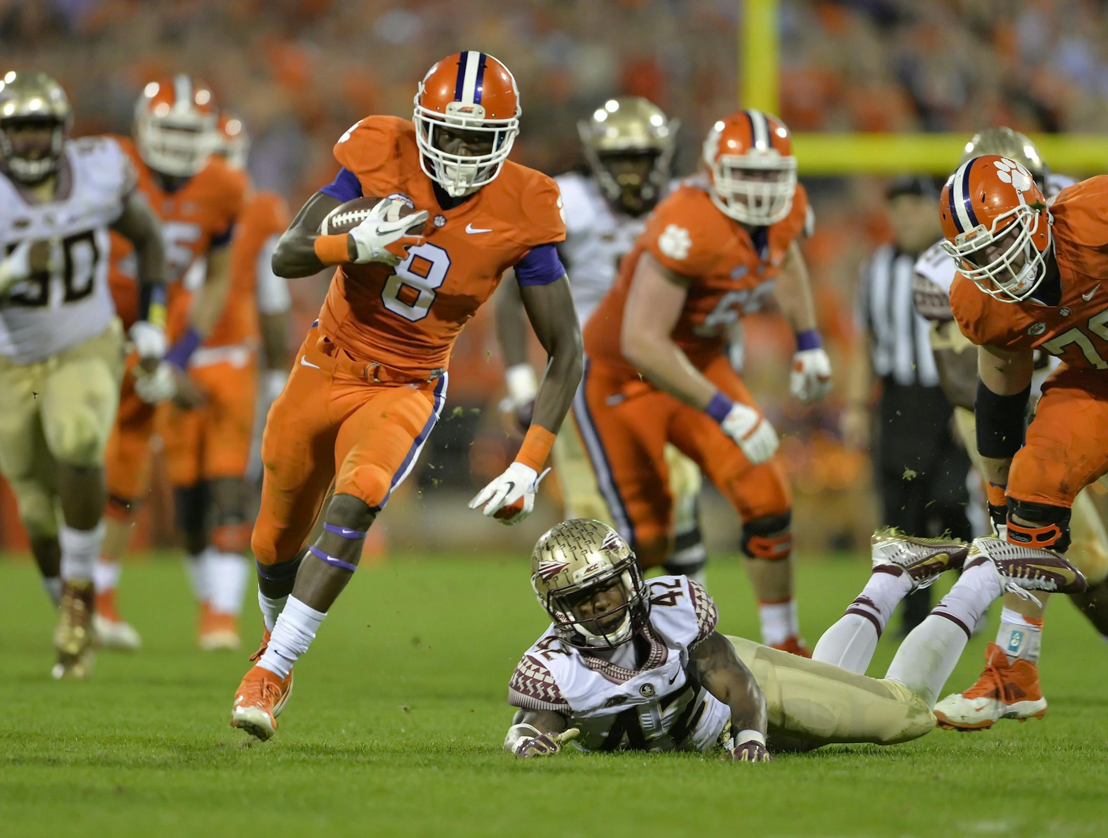 Clemson's Deon Cain (8) rushes out of the tackle attempt by Florida State's Lamarcus Brutus on his way to a touchdown during the second half of an NCAA college football game Saturday, Nov. 7, 2015, in Clemson, S.C. Clemson won 23-13. (AP Photo/Richard Shiro)