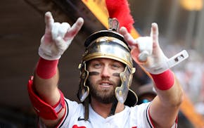 The Twins' Kody Clemens wears a sign of success in the dugout after his sixth-inning home run Saturday.