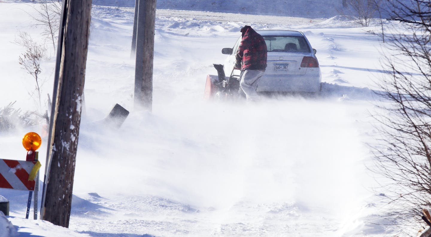 A strong westerly wind kicked up snow Sunday afternoon drifting it over area roads and parking lots. A St. Paul resident used a snow blower in an attempt to free his car stuck in an alley off Payne Ave. in St. Paul. (MARLIN LEVISON/STARTRIBUNE(mlevison@startribune.com)