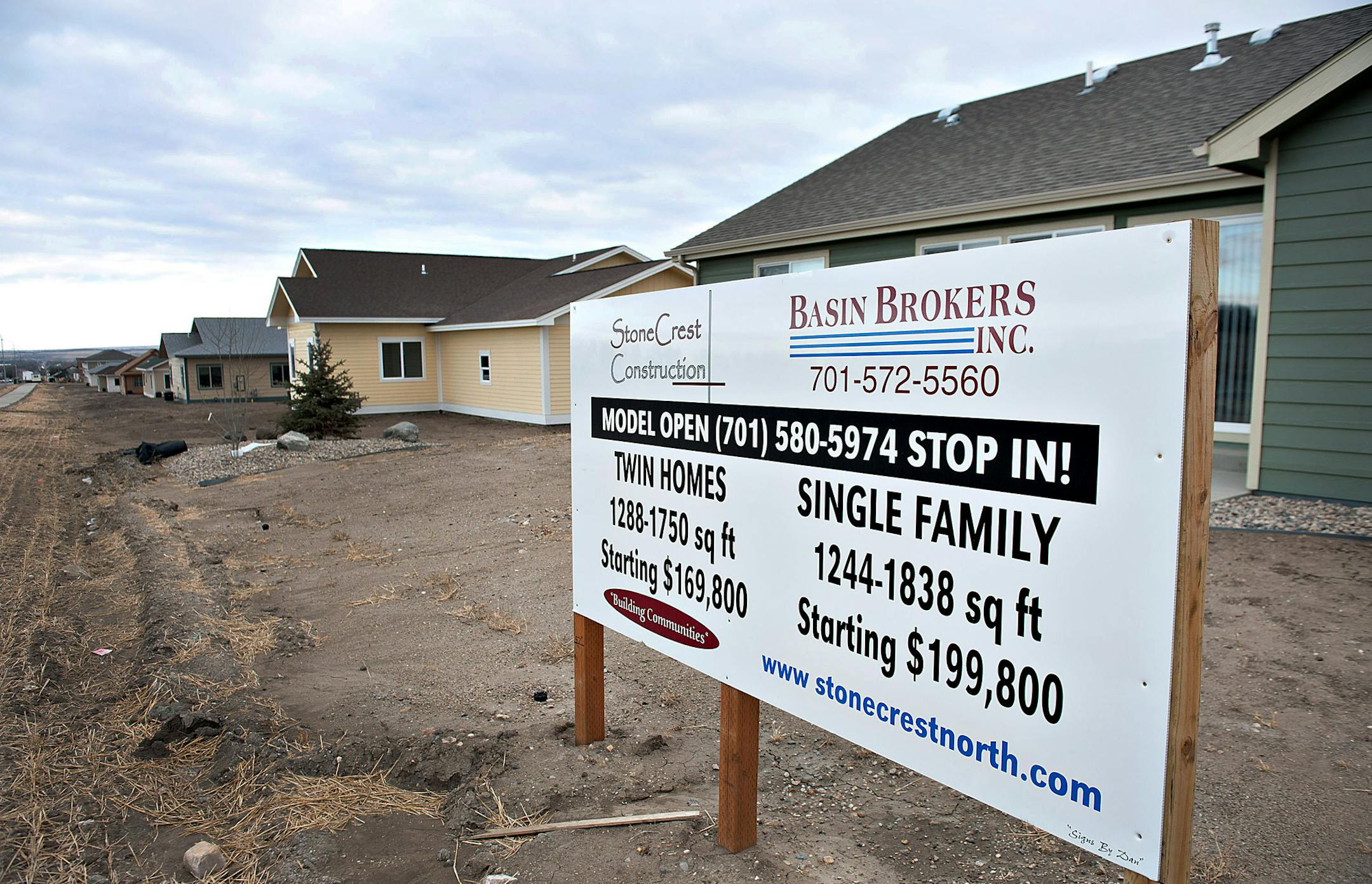 Single-family homes stand in a new housing development in Williston, North Dakota, U.S., on Monday, Feb. 13, 2012. The oil boom fueling the nation's lowest unemployment rate has put pressure on North Dakota's tight housing market. Officials expect some 1,200 apartments and single-family homes to be completed in Williston by summer. North Dakota will hold its Republican presidential caucus on March 6. Photographer: Daniel Acker/Bloomberg ORG XMIT: 140227233
