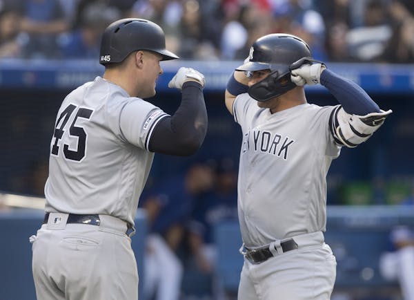 New York Yankees' Gleyber Torres, right, is met by teammate Luke Voit after hitting a two run home run against the Toronto Blue Jays in the sixth inni