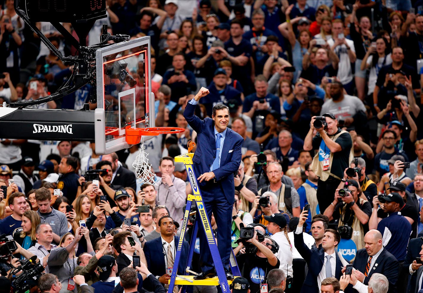 Villanova head coach Jay Wright reacts after cutting down the net after beating Michigan 79-62 in the championship game of the Final Four in San Antonio.