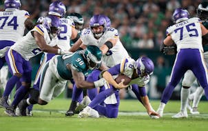 With backup center Austin Schlottmann (65) unable to protect Kirk Cousins, Eagles defensive tackle Jordan Davis sacked the Vikings QB in the first qua
