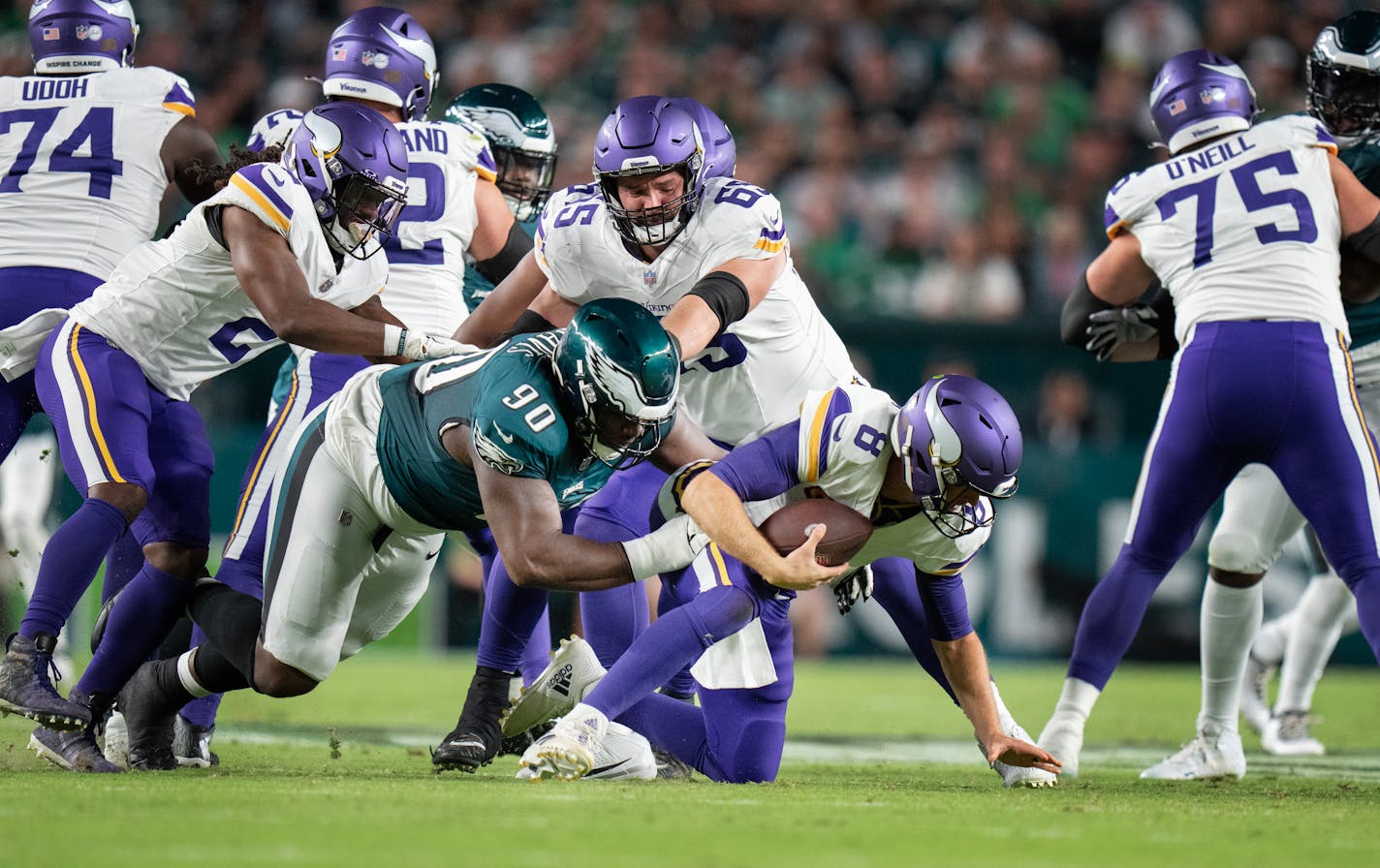 With backup center Austin Schlottmann (65) unable to protect Kirk Cousins, Eagles defensive tackle Jordan Davis sacked the Vikings QB in the first quarter Thursday.