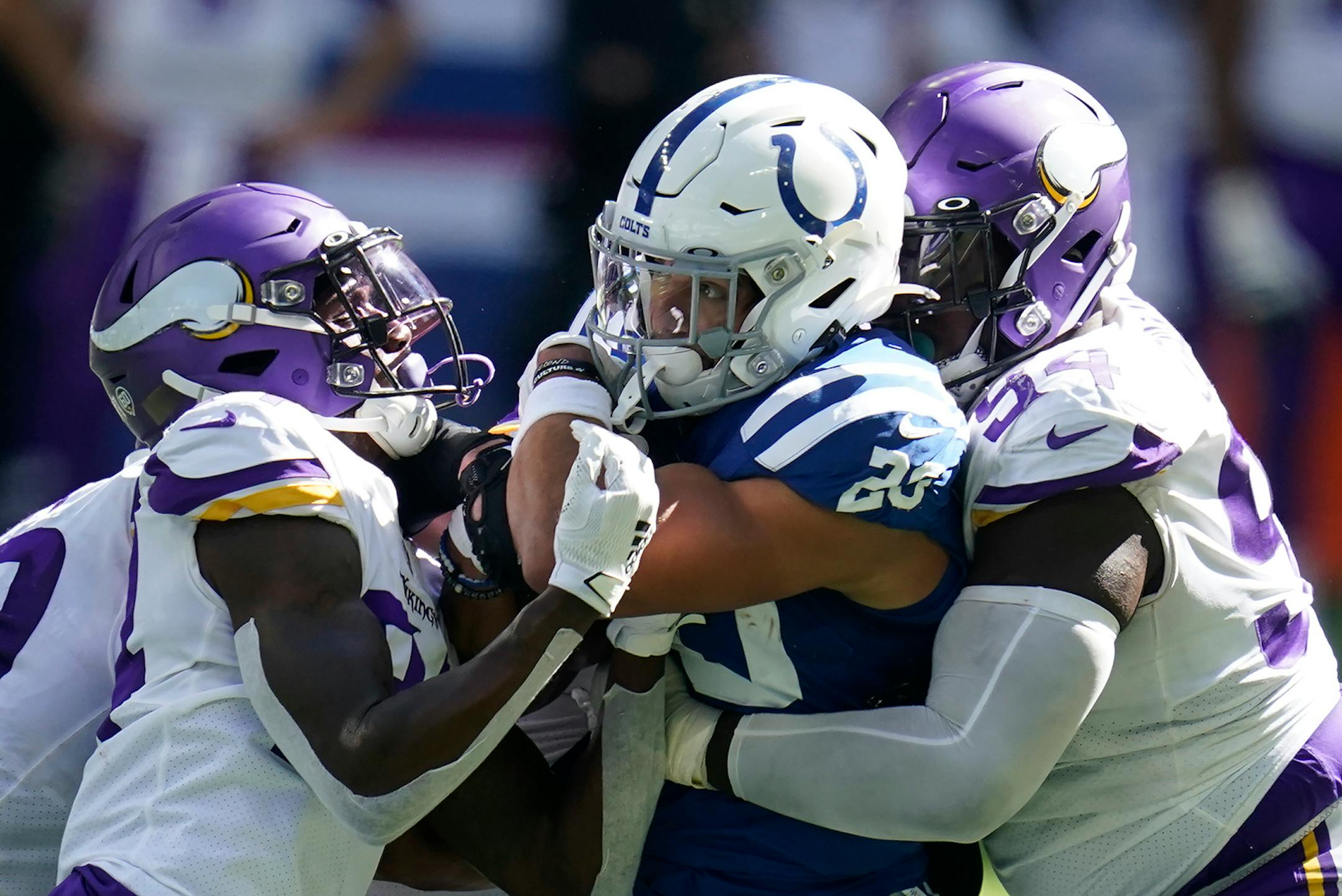 Indianapolis Colts' Jonathan Taylor (28) is tackled by Minnesota Vikings' Harrison Smith (22) and Jaleel Johnson during the second half of an NFL football game, Sunday, Sept. 20, 2020, in Indianapolis.